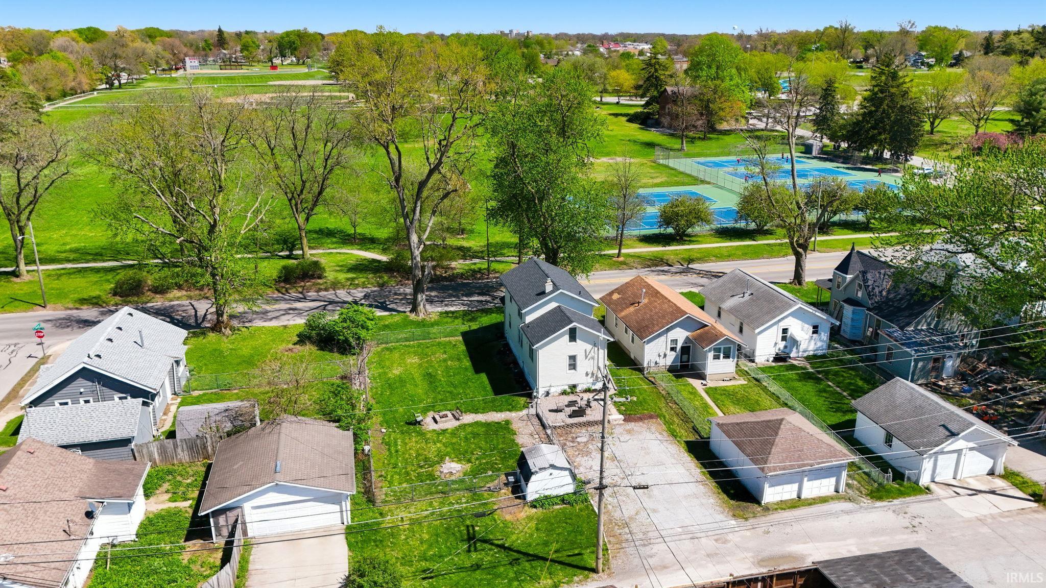 Expansive green space and tennis courts visible from the property
