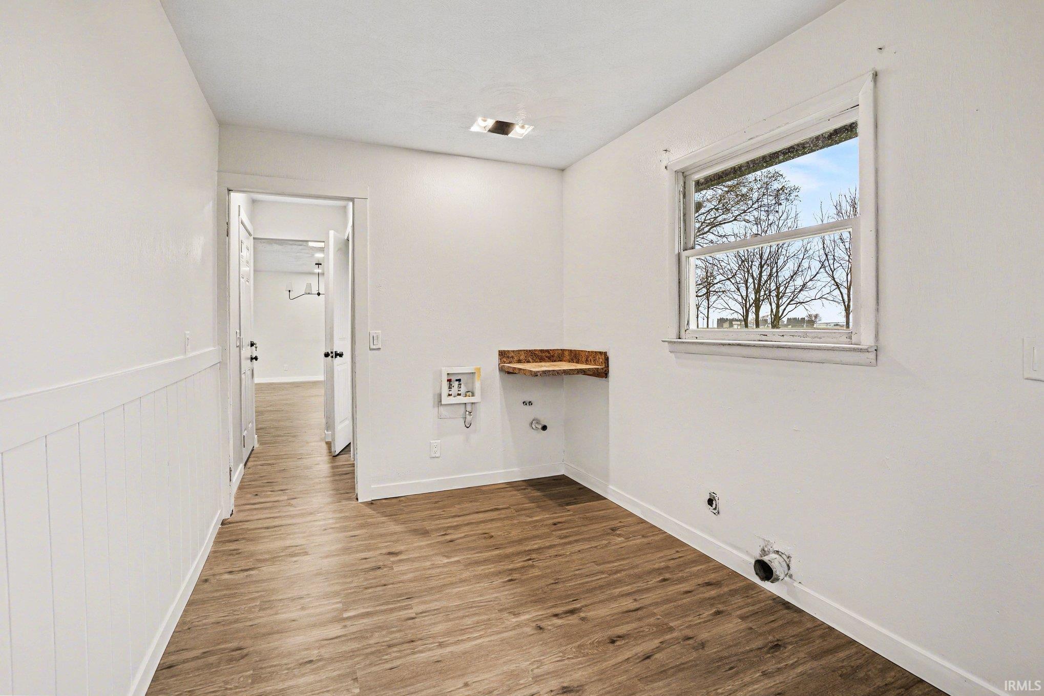 Laundry room with dark wood-type flooring, gas dryer hookup, and washer hookup