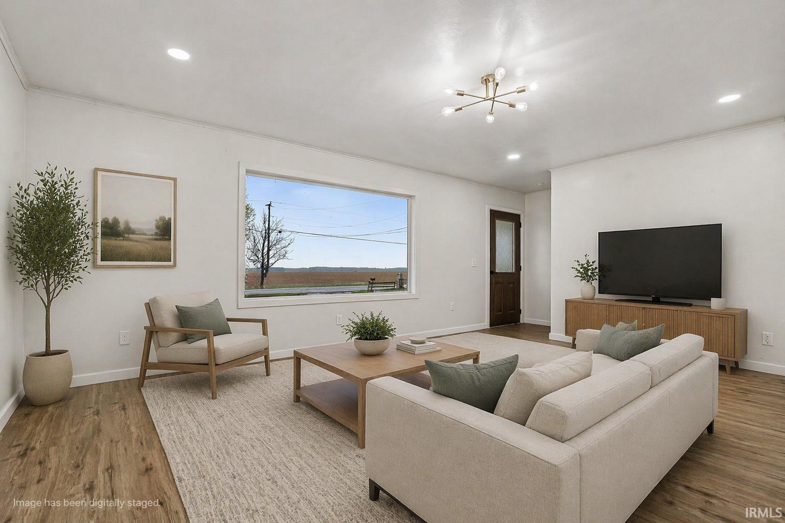 Living room featuring wood finished floors, recessed lighting, and crown molding Virtually staged