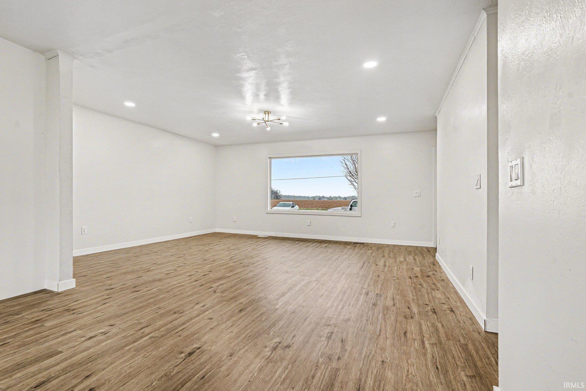 Spare room with light wood-style floors and recessed lighting
