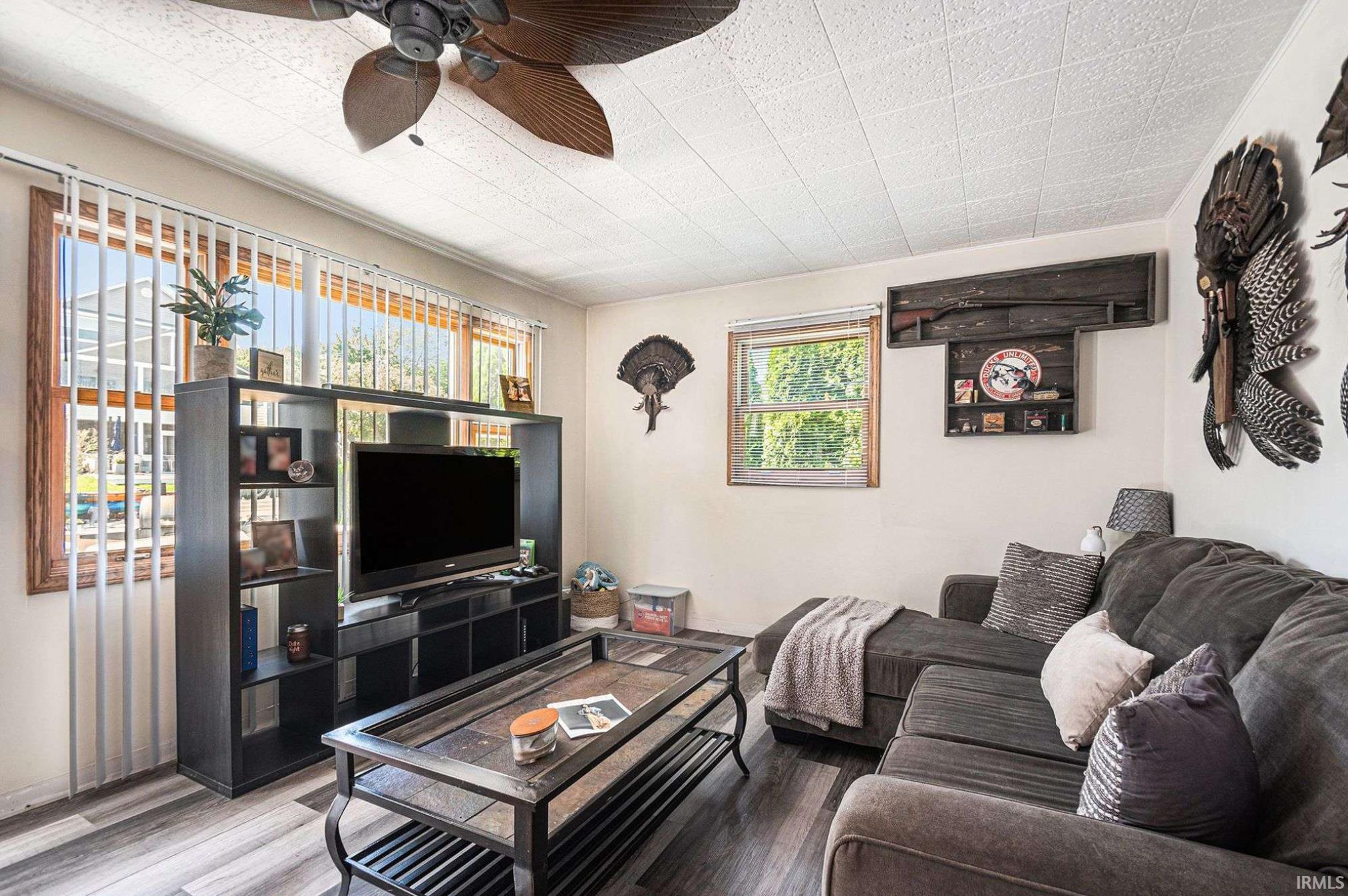 Living area featuring light wood-finish flooring and a textured ceiling