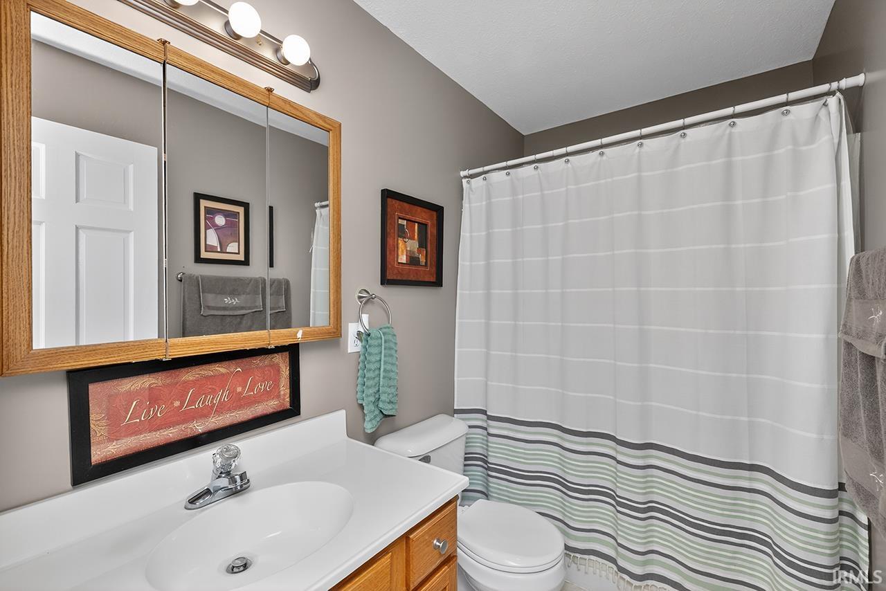 Full bathroom with vanity and a shower with curtain