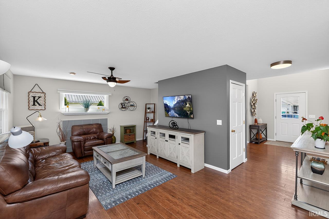 Living room with hardwood / wood-style floors and a ceiling fan