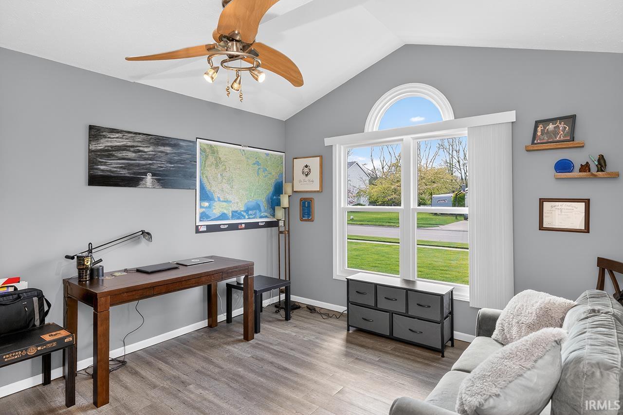 Home office with a ceiling fan and wood finished floors