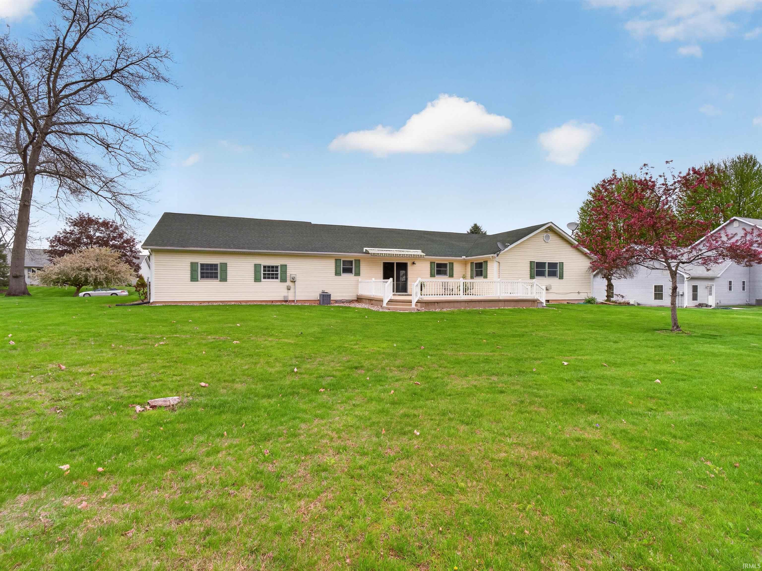 Expansive rear yard featuring a manicured lawn