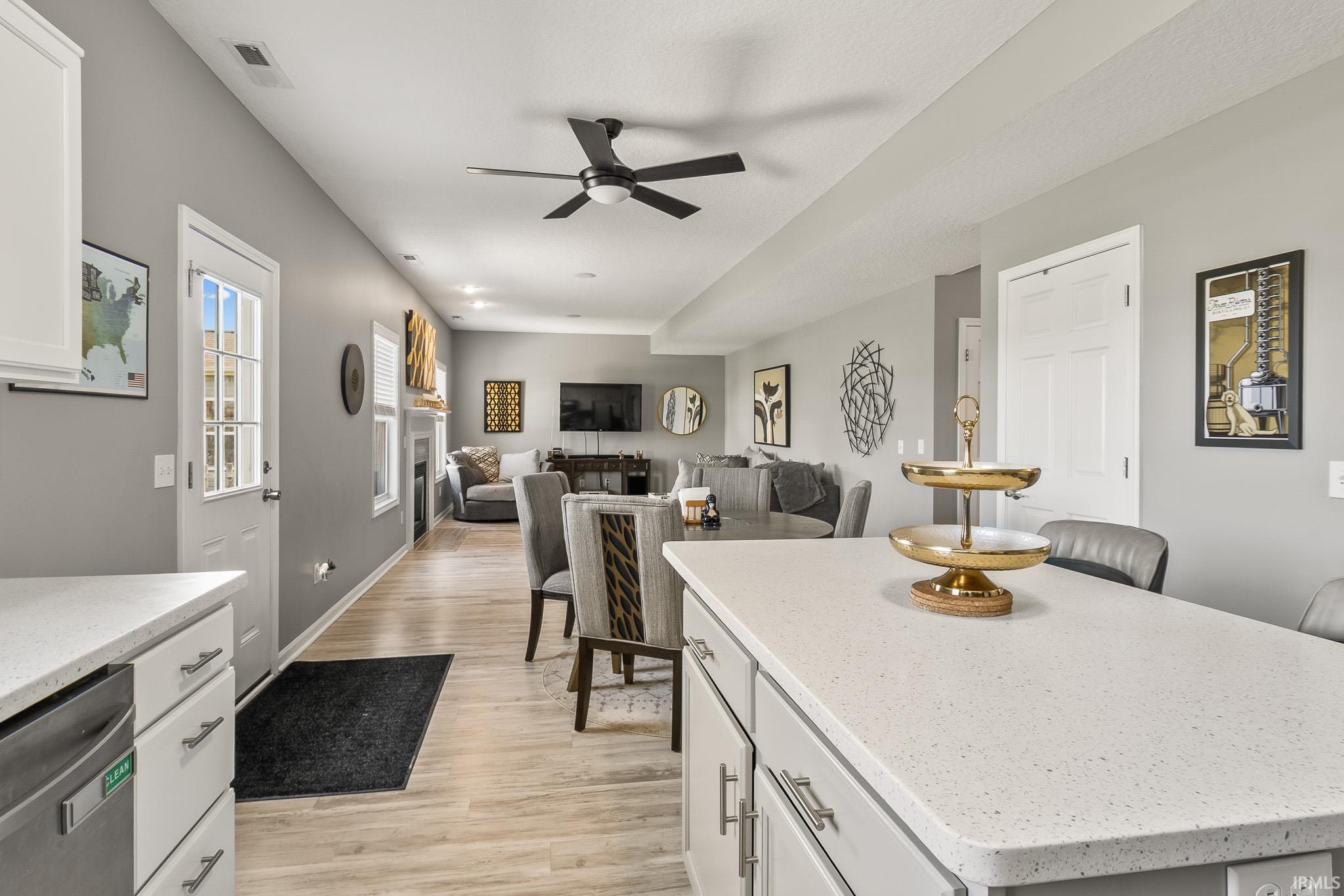 Kitchen island with light-toned countertop and light gray cabinetry