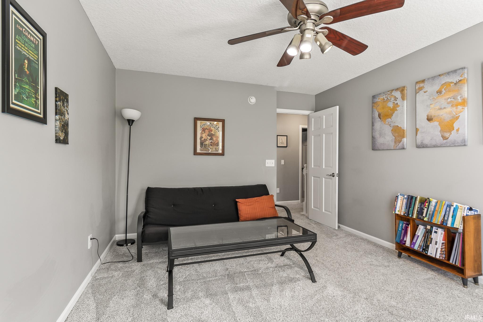 Room featuring light gray wall paint, light gray carpet flooring, and white baseboards