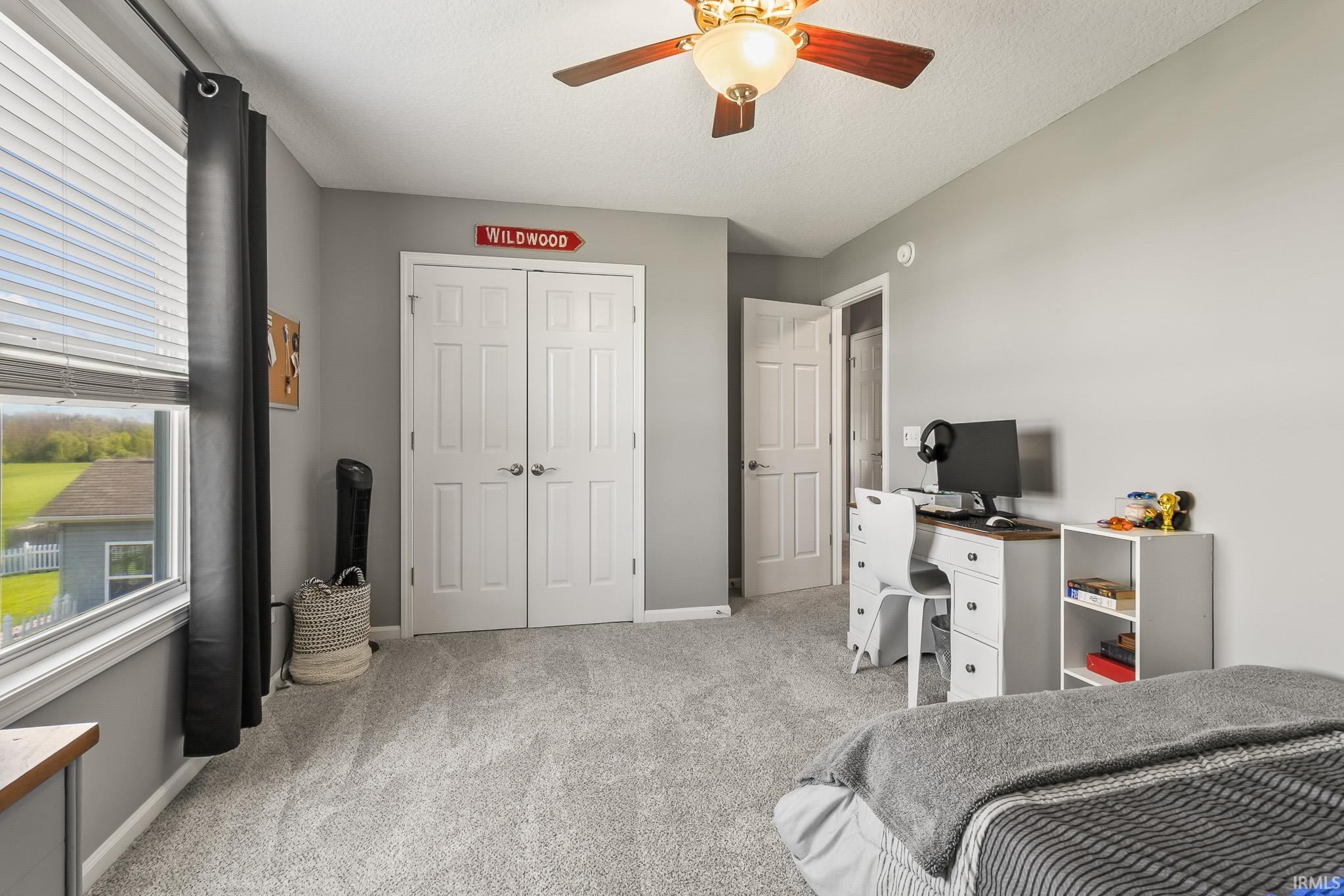 Bedroom featuring light gray wall paint and gray carpeting