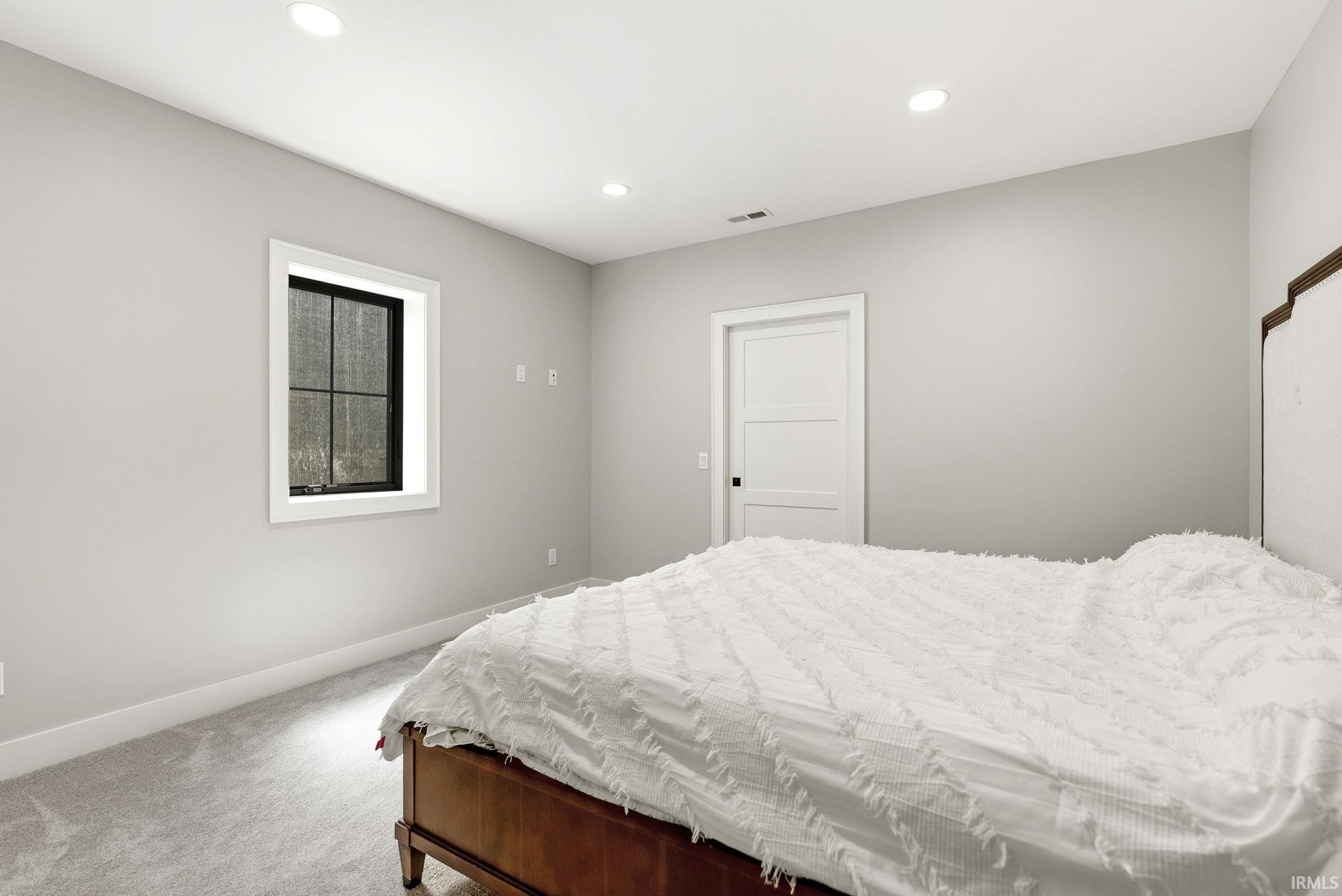 Bedroom featuring recessed lighting, light gray walls, and gray carpeting