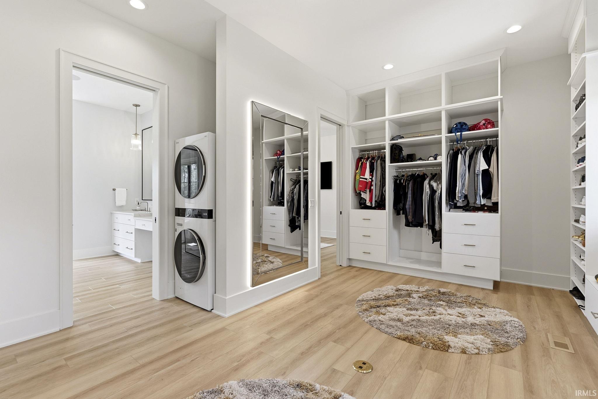 Custom closet system featuring built-in shelving, drawers, and hanging rods