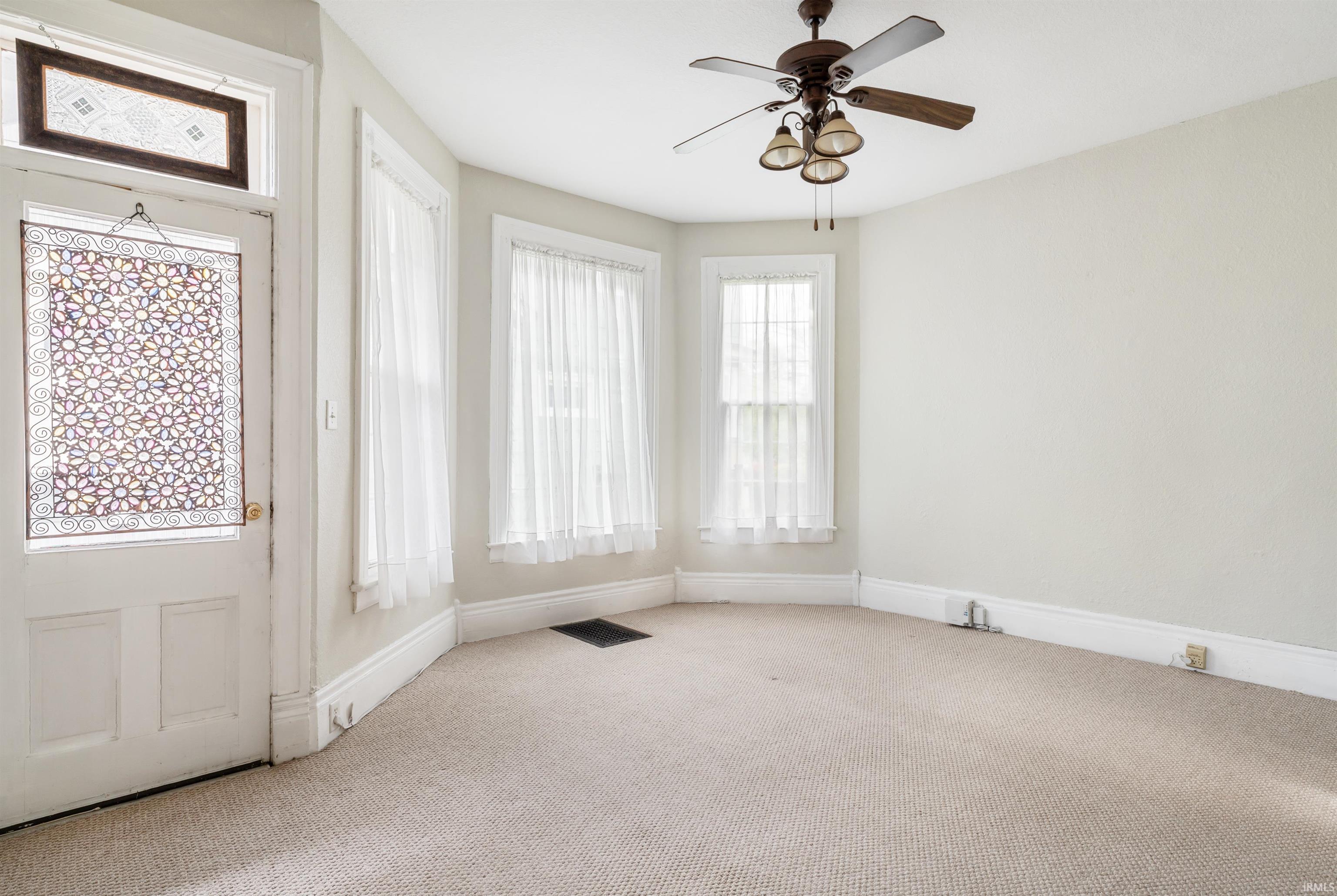 Neutral-toned carpet flooring complementing light wall paint