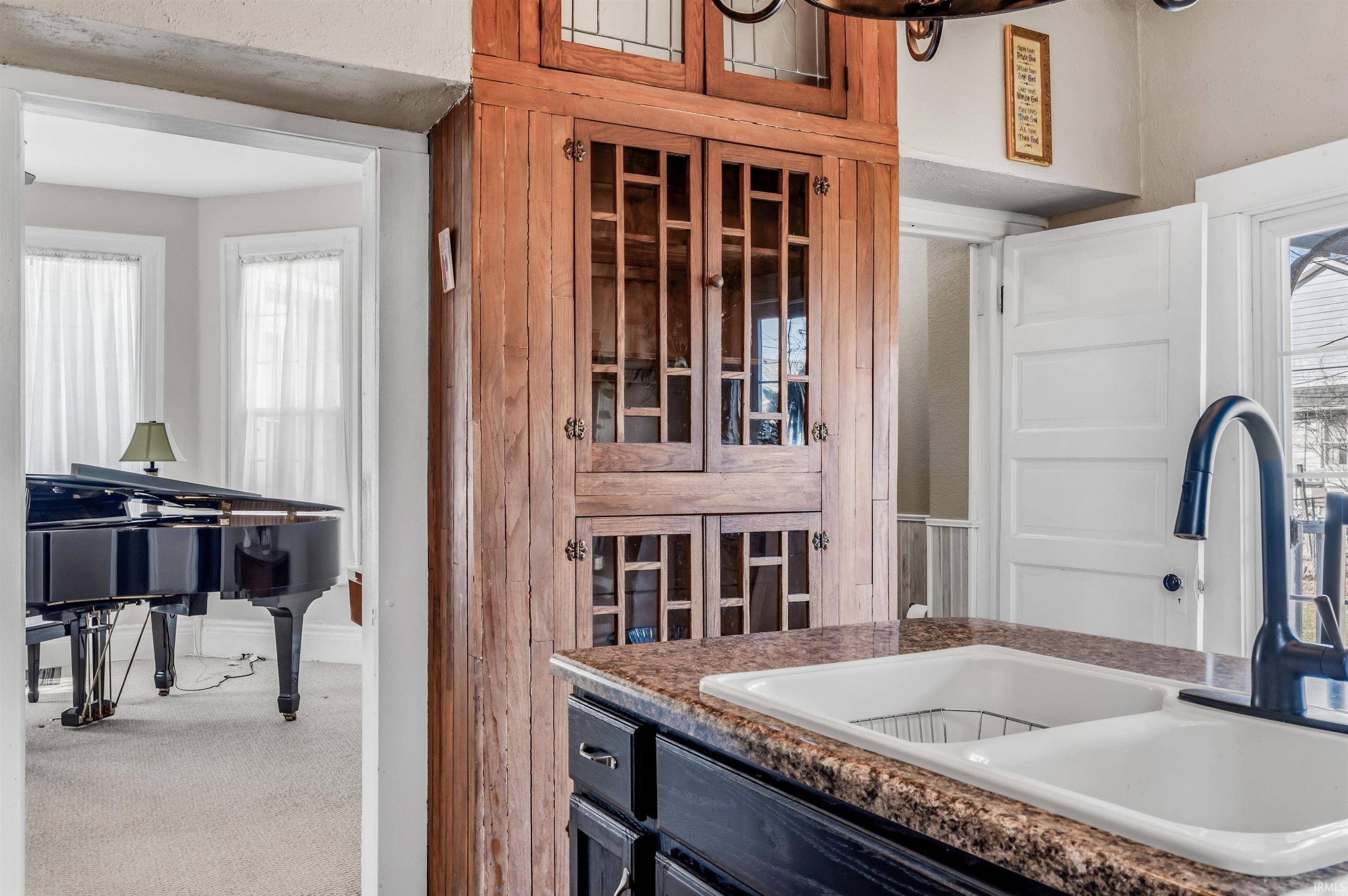 Kitchen featuring a sink and dark stone countertops