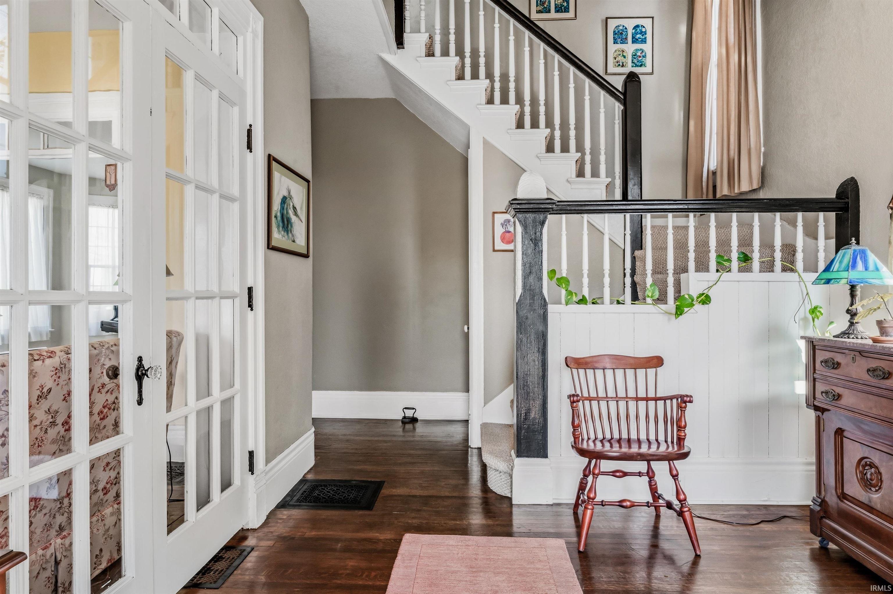 Foyer with stairway and dark wood-type flooring
