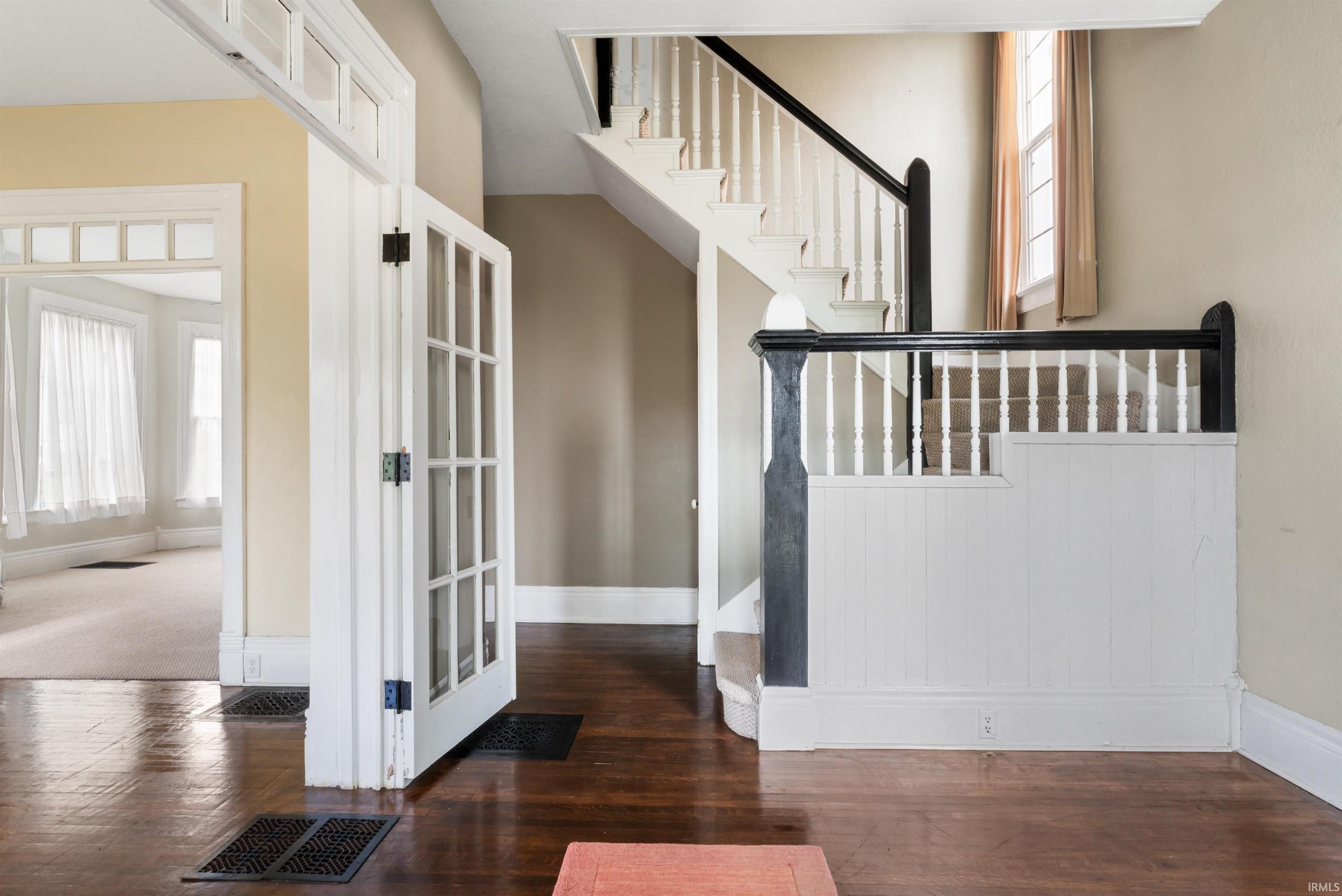 Grand staircase with black newel posts and white spindles