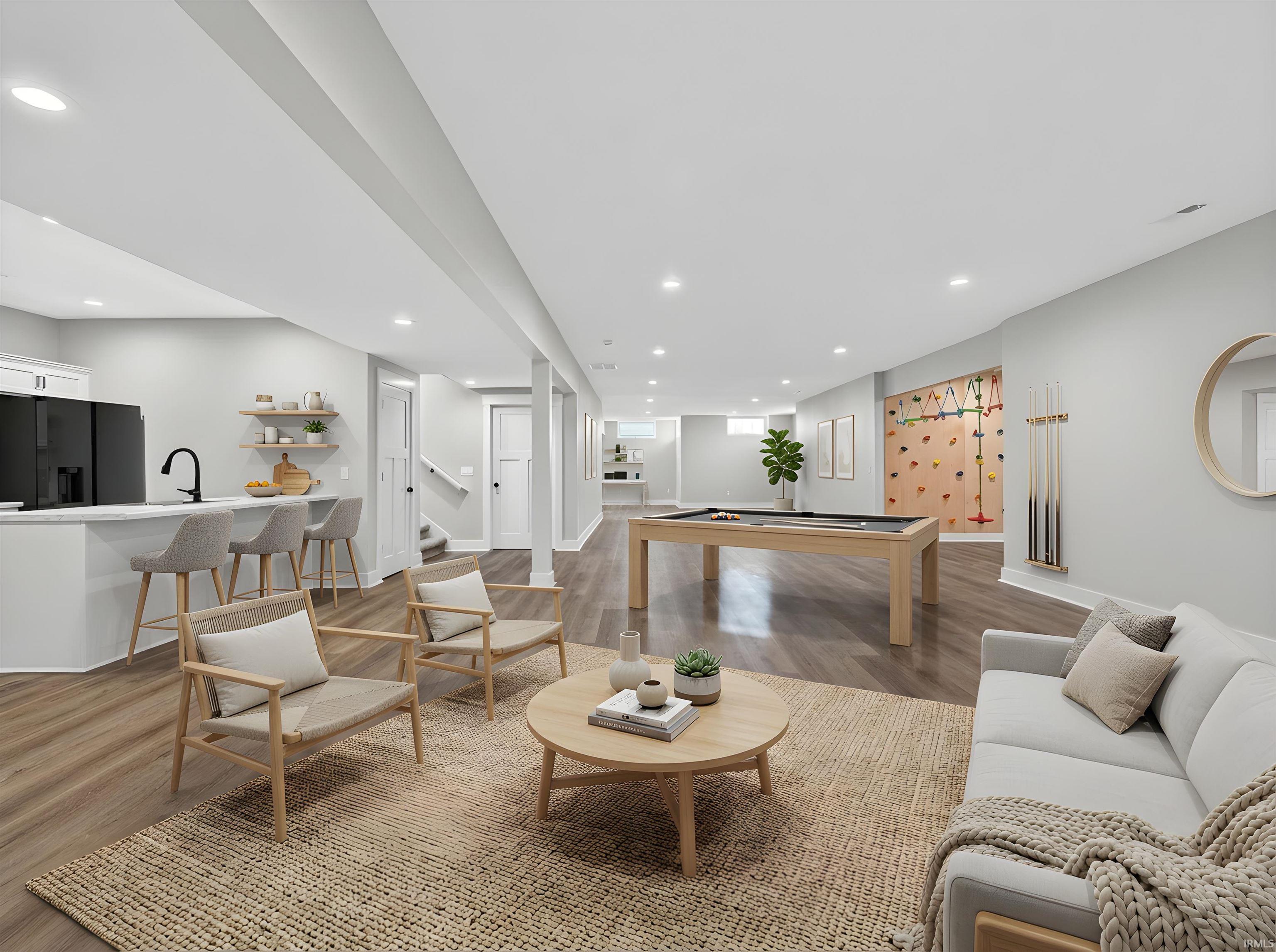Open-concept lower level featuring wood-finish flooring and recessed lighting. Full Kitchen