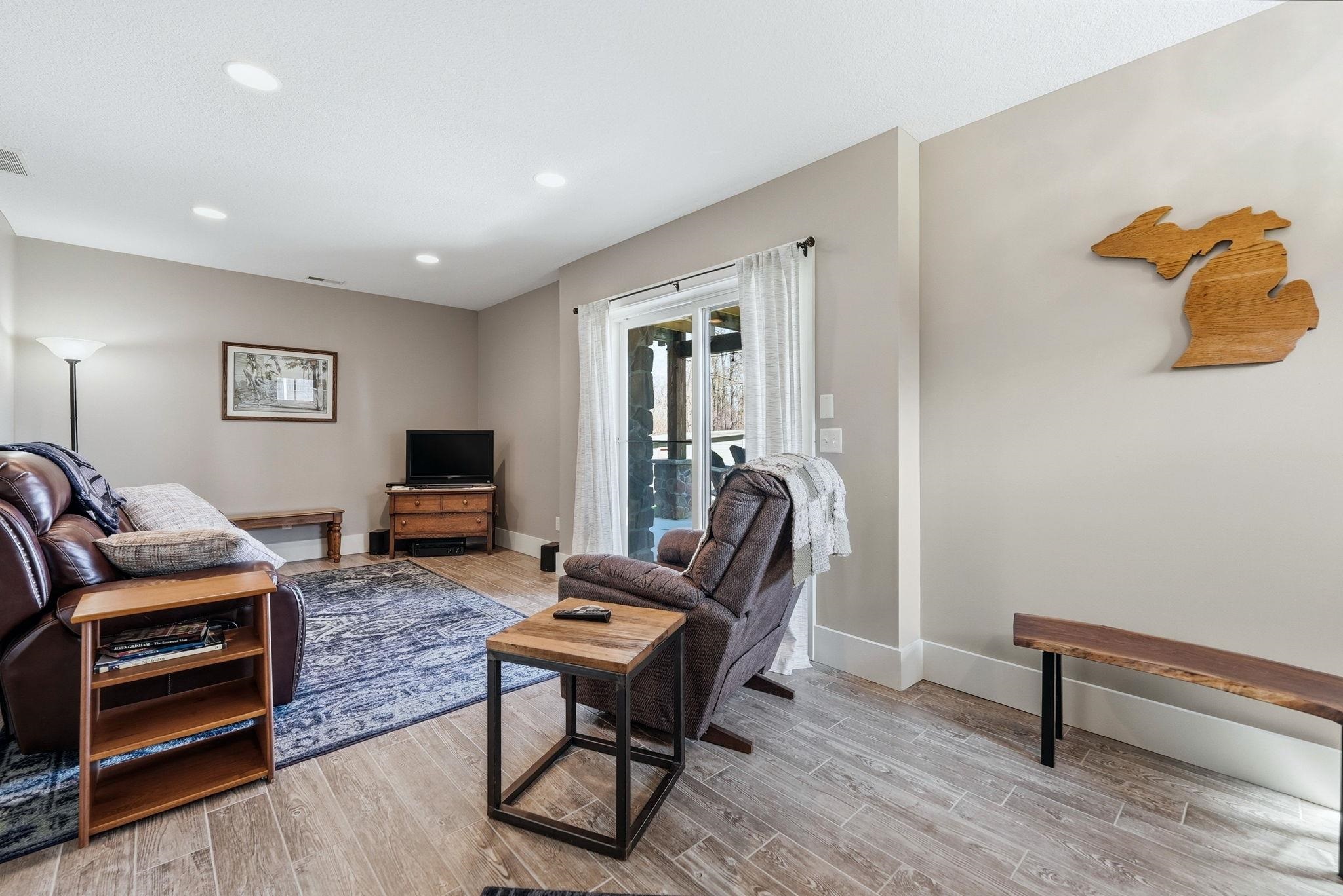 Spacious room featuring wood-finish flooring, recessed lighting, and a neutral wall color