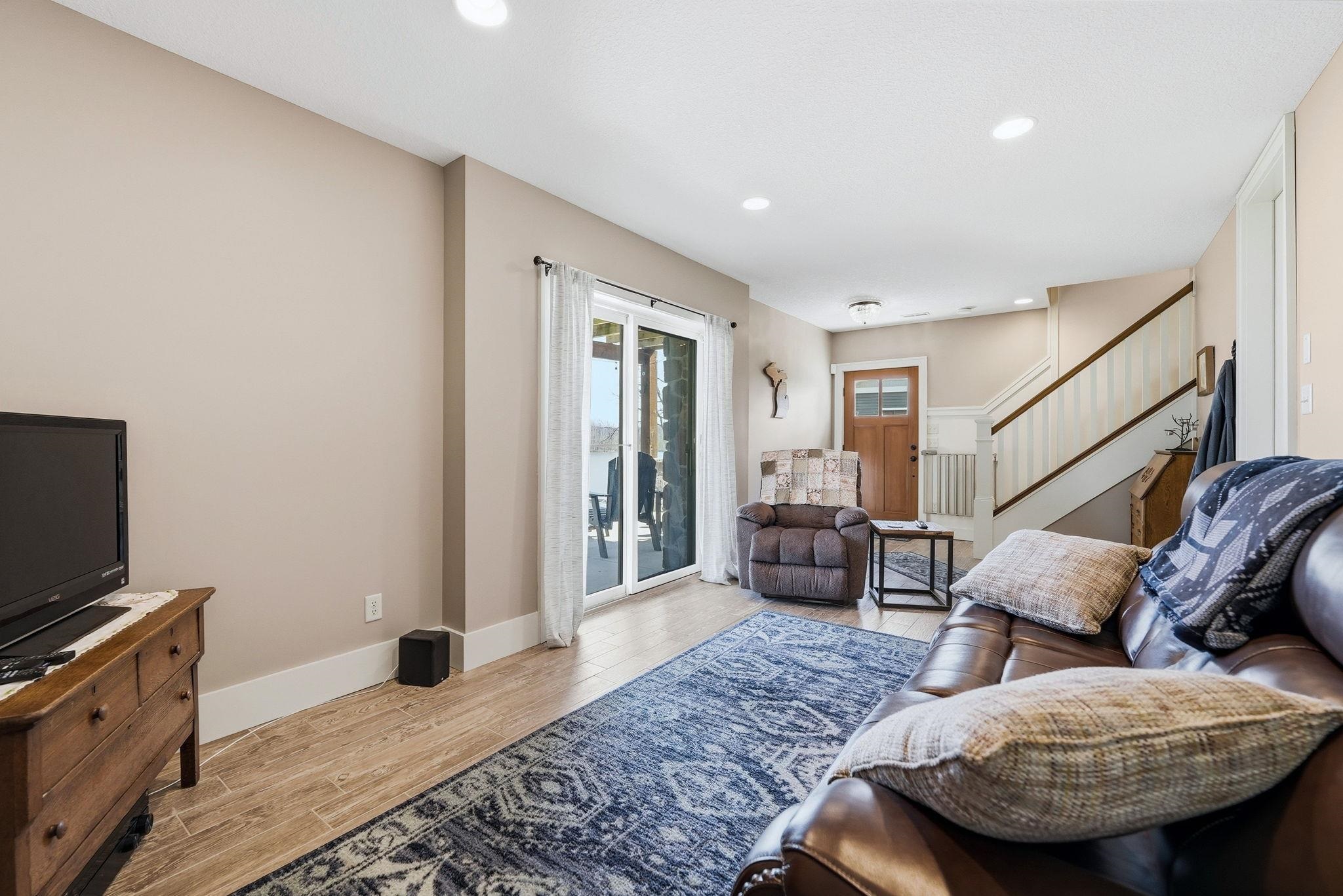 Living area featuring light-toned walls and wood-finish flooring