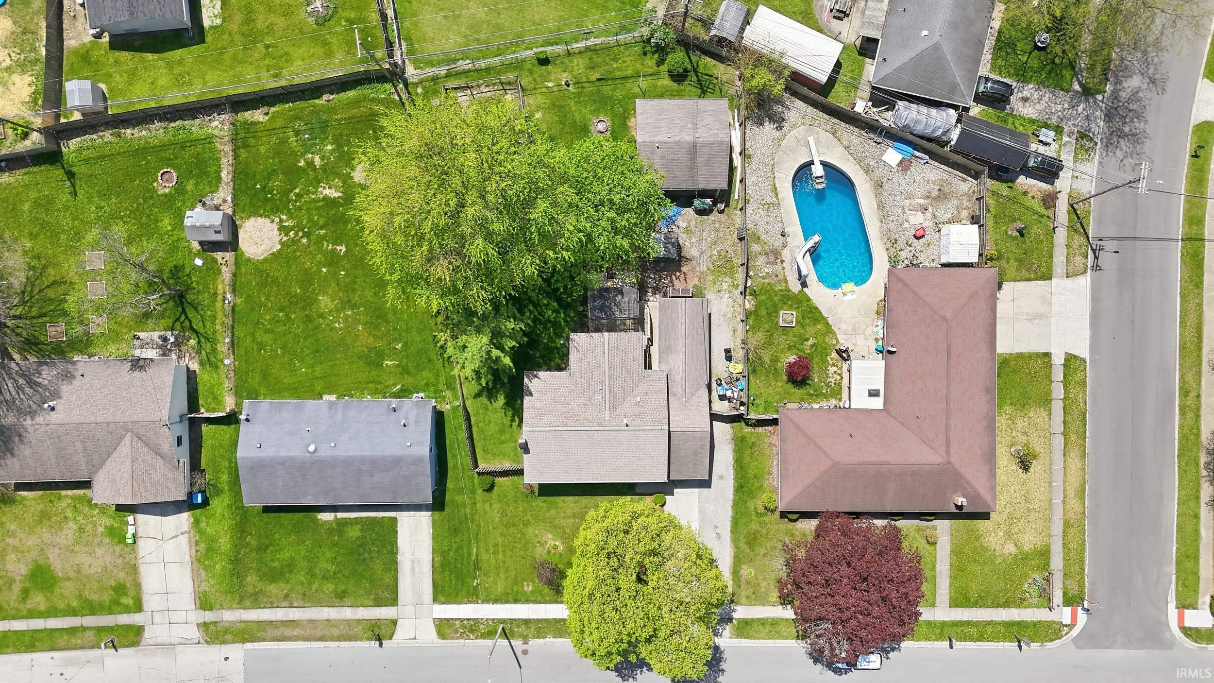 Aerial view showcasing a residential property with an in-ground swimming pool