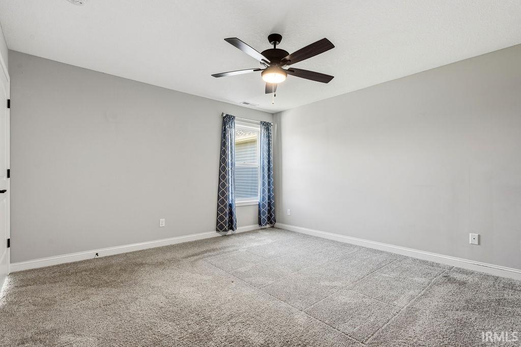 Neutral gray walls complement the textured gray carpeting