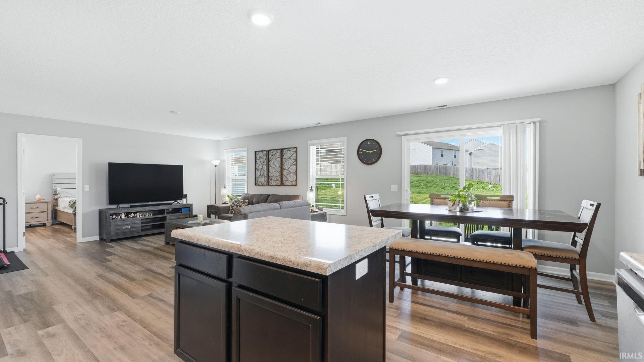 Spacious interior featuring wood-finish flooring and light gray walls
