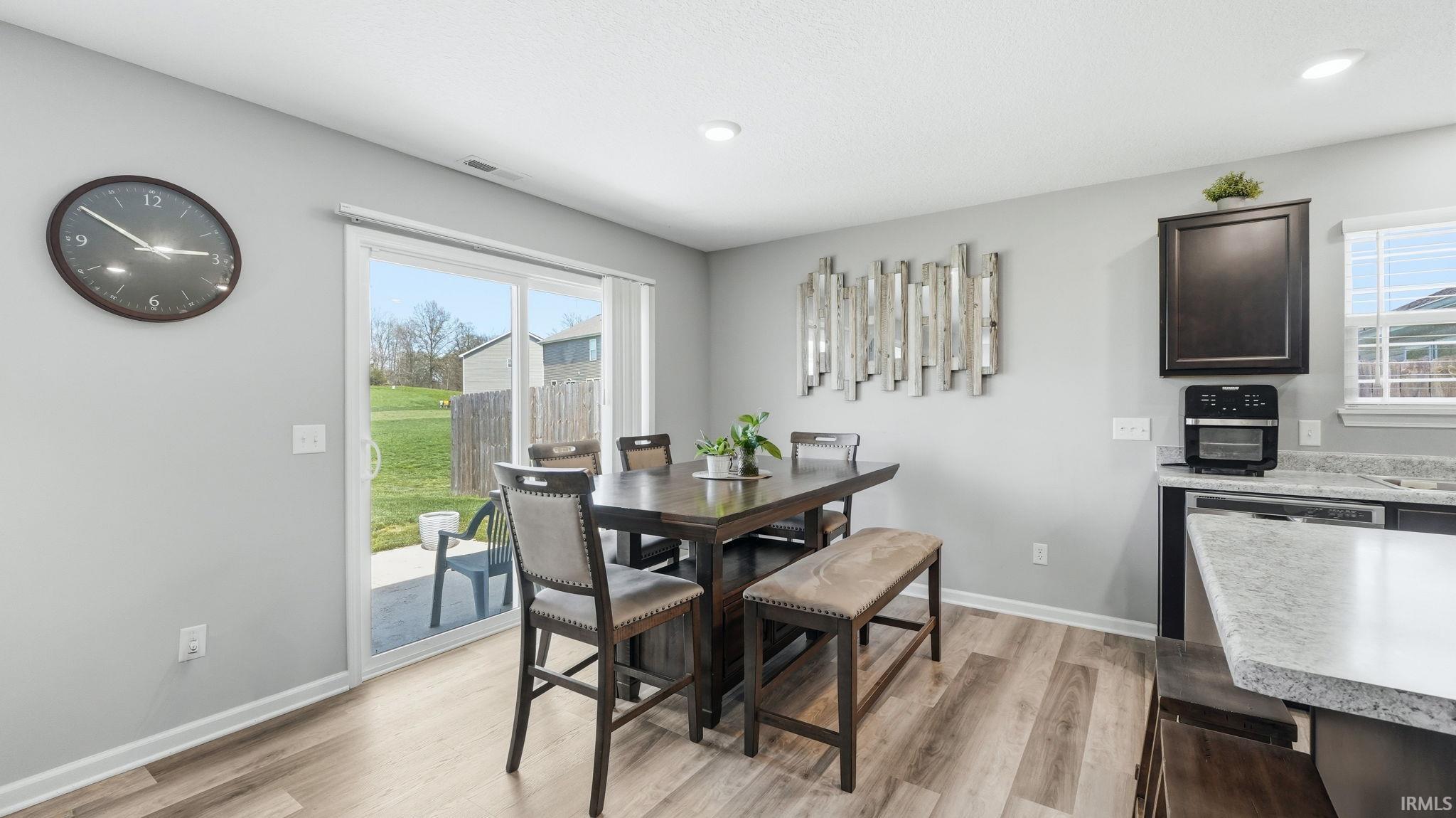 Dining area featuring wood-finish flooring and light gray walls
