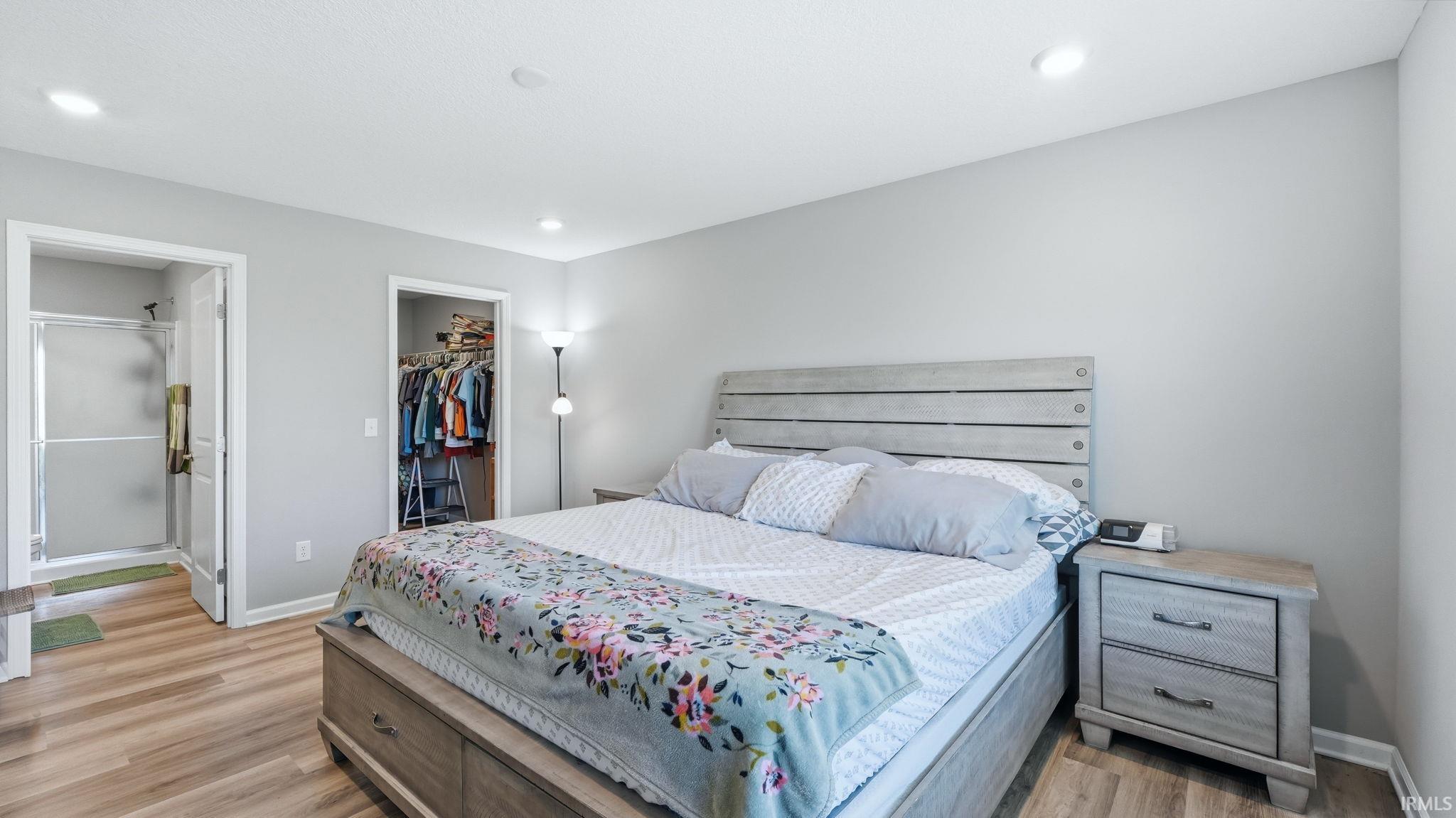 Bedroom featuring light wood-finish flooring, recessed lighting, and a neutral wall color