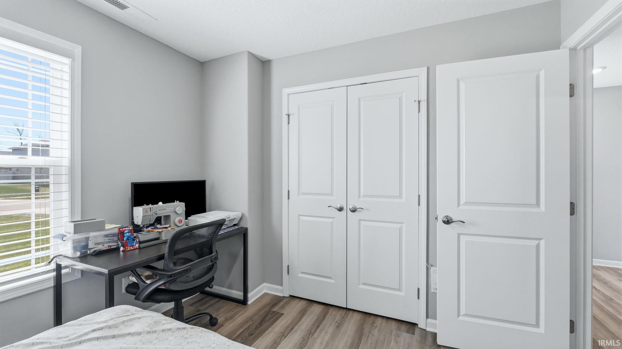 Neutral gray wall paint complementing a light wood-finish flooring