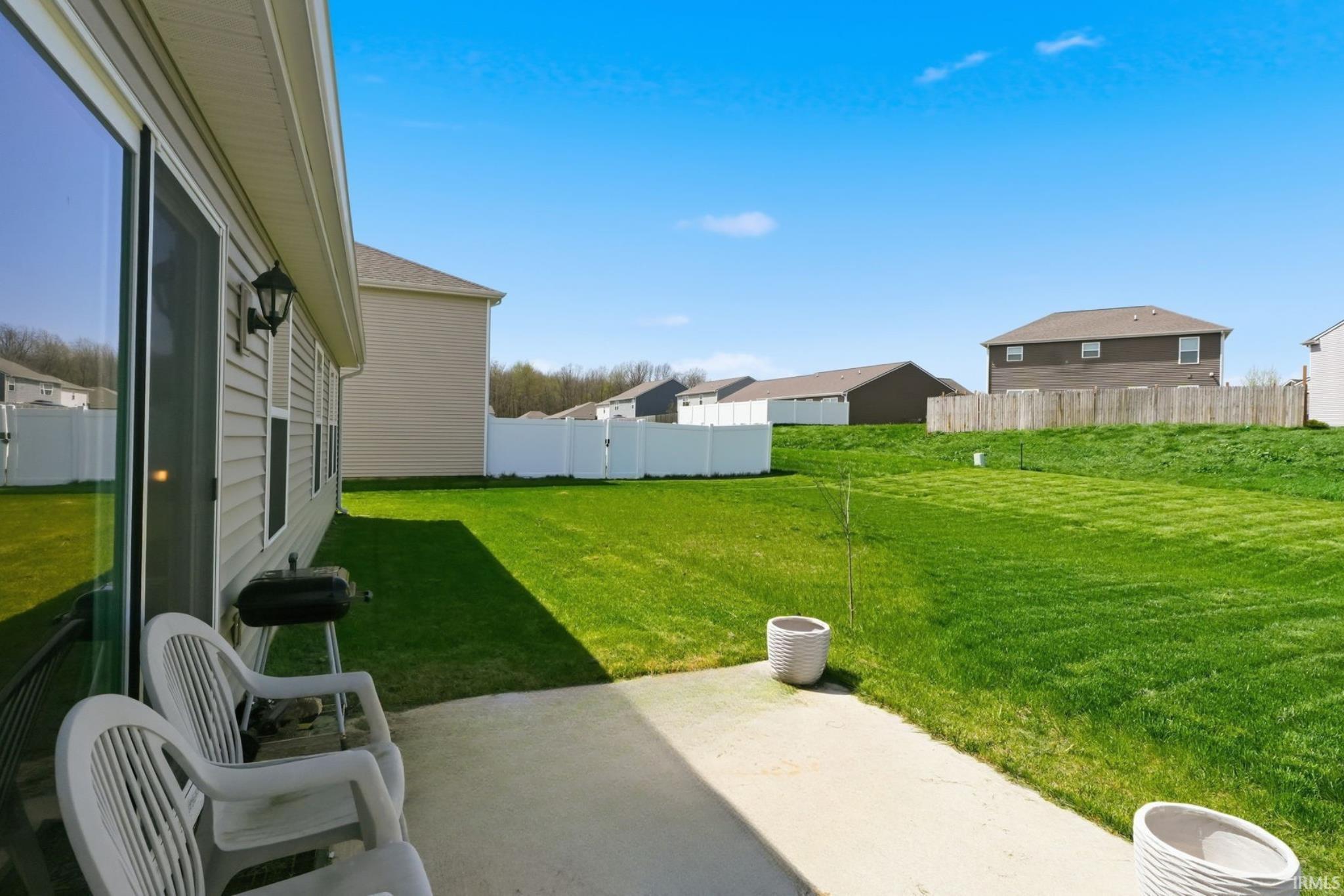 Concrete patio with a sliding glass door entry to the residence
