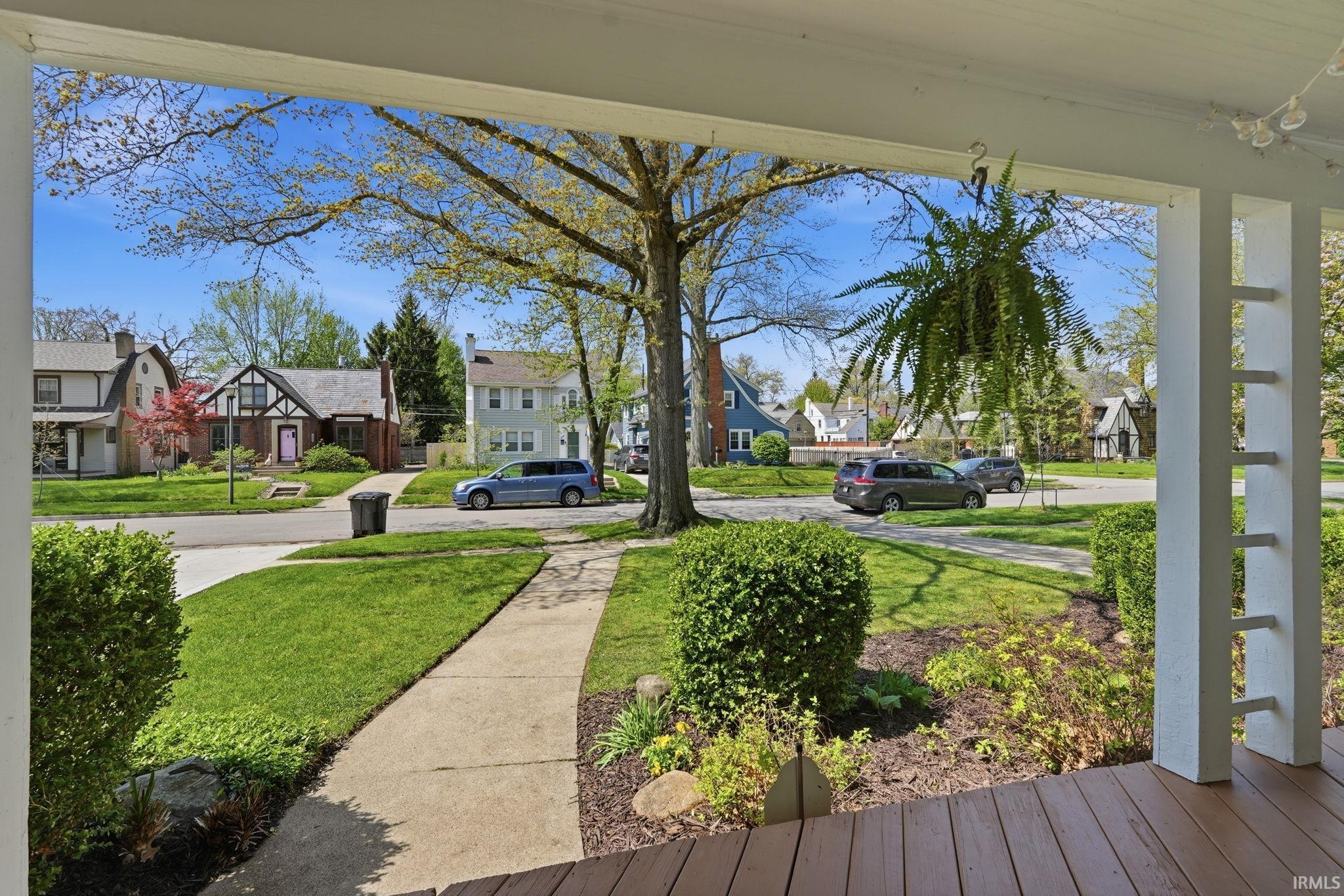 Inviting front porch with rich brown wood-finish flooring