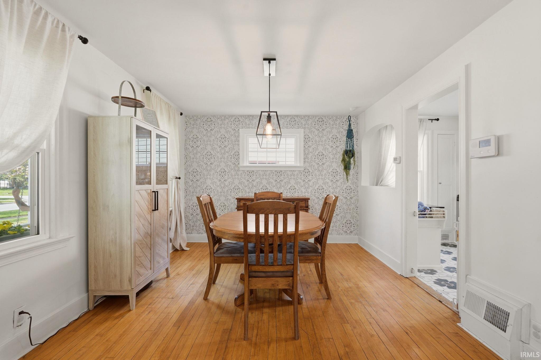 Hardwood-style flooring throughout, complemented by a geometric accent wall