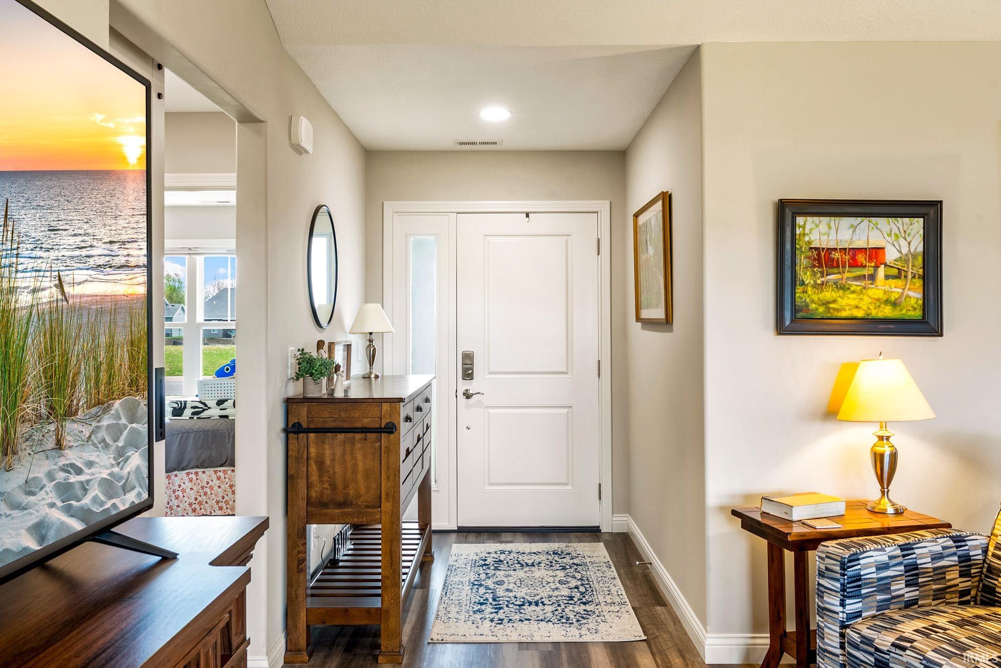 Entryway featuring a solid white door with frosted glass sidelight, wood-finish flooring, recessed lighting, and light-toned wall paint