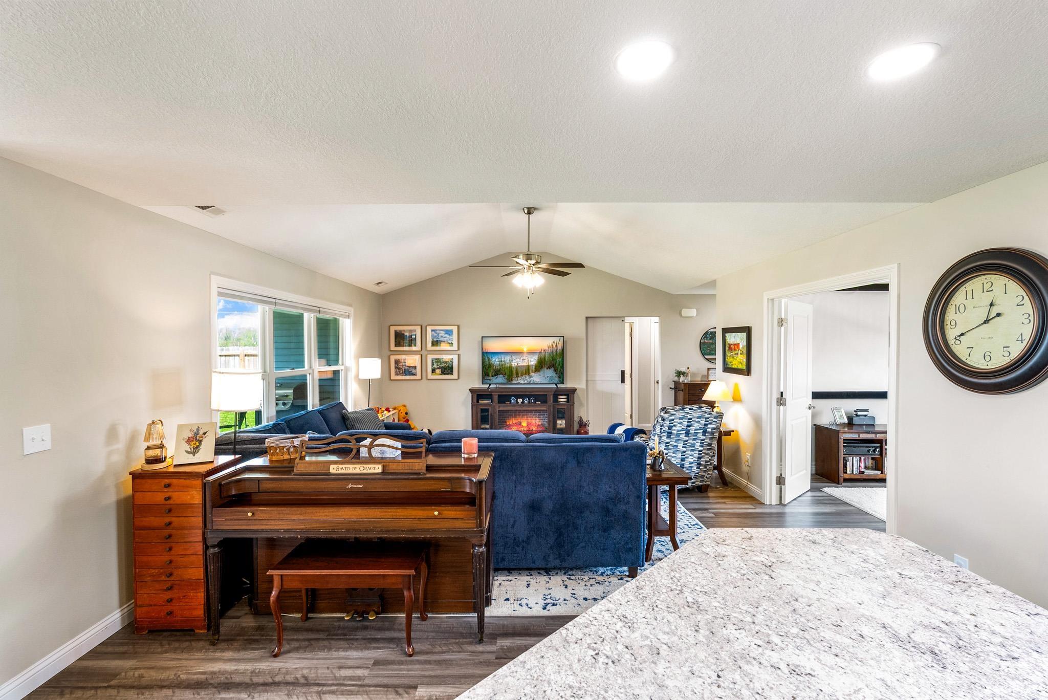 The main living area features vaulted ceilings with recessed lighting and a ceiling fan