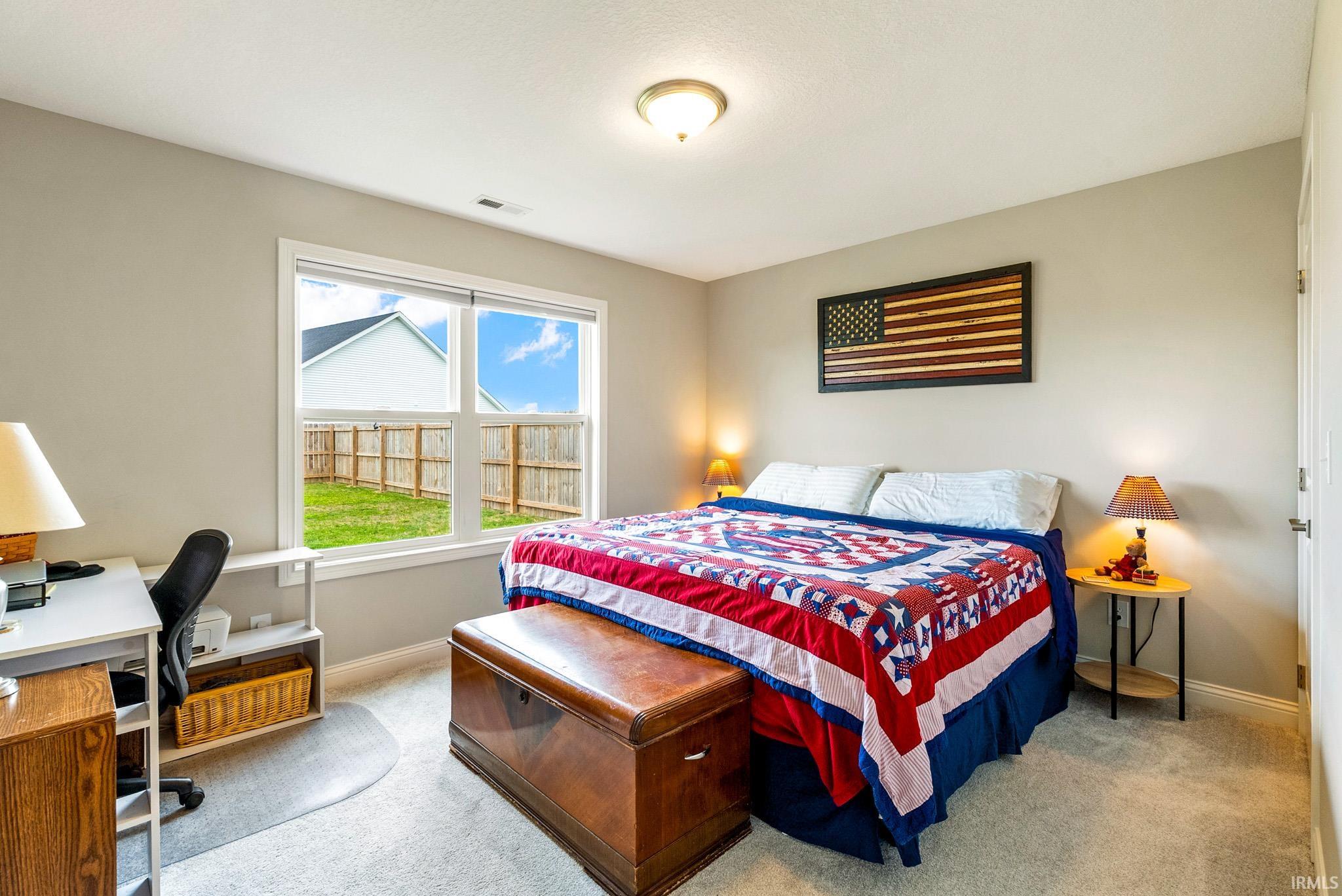 Bedroom featuring light neutral wall paint and light carpet flooring