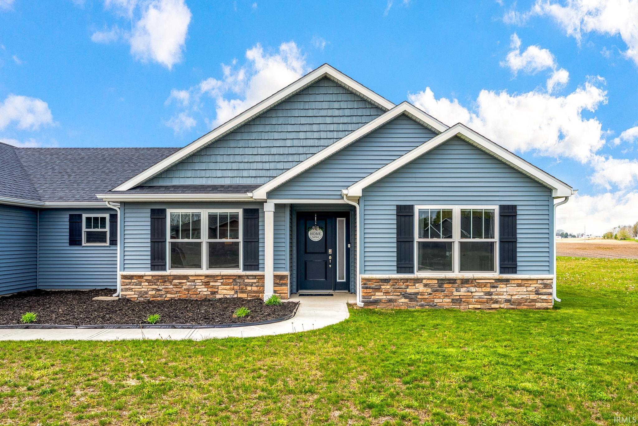 Light blue siding facade with stone veneer accents