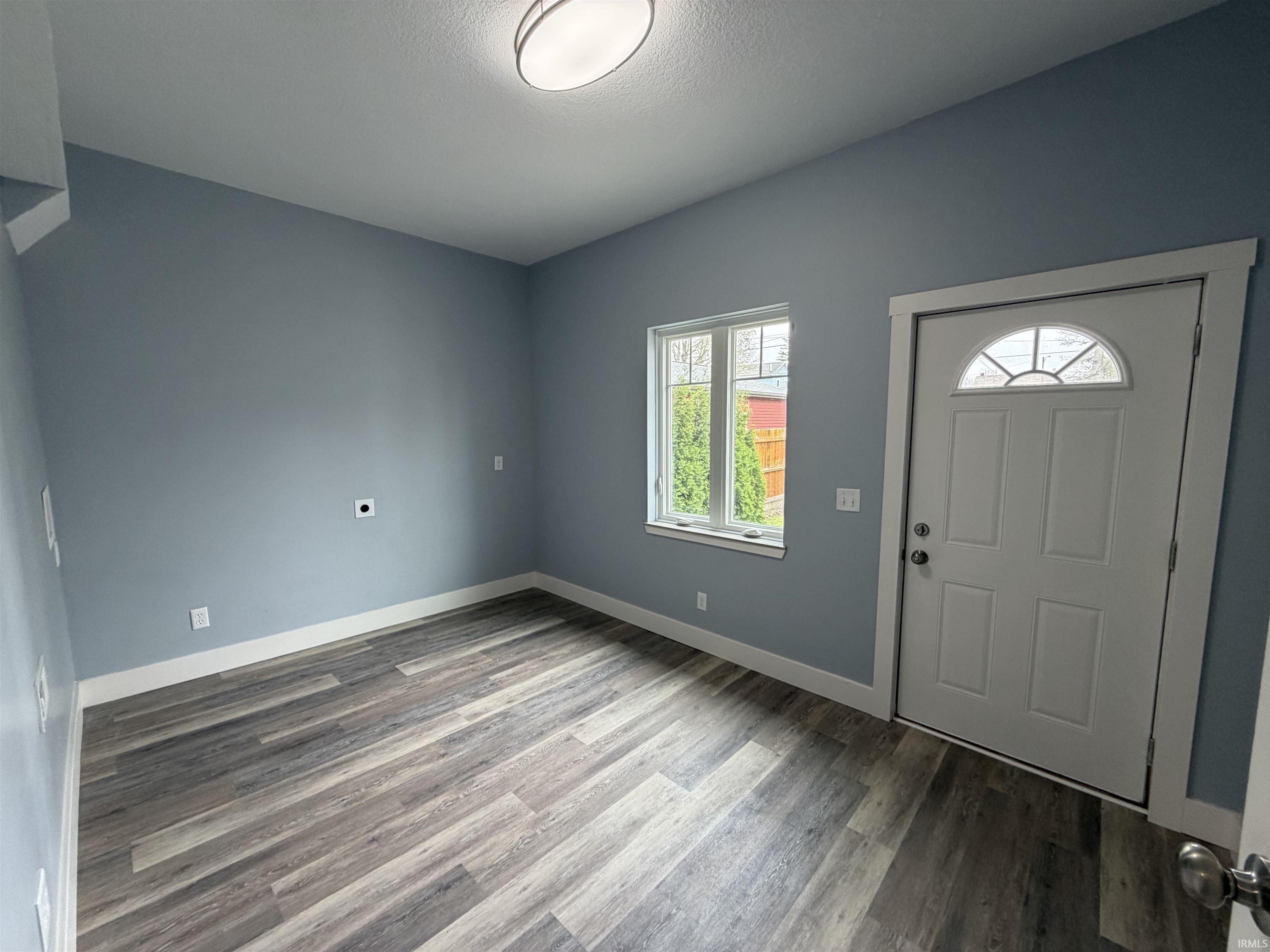 Entryway with light wood-style floors and baseboards