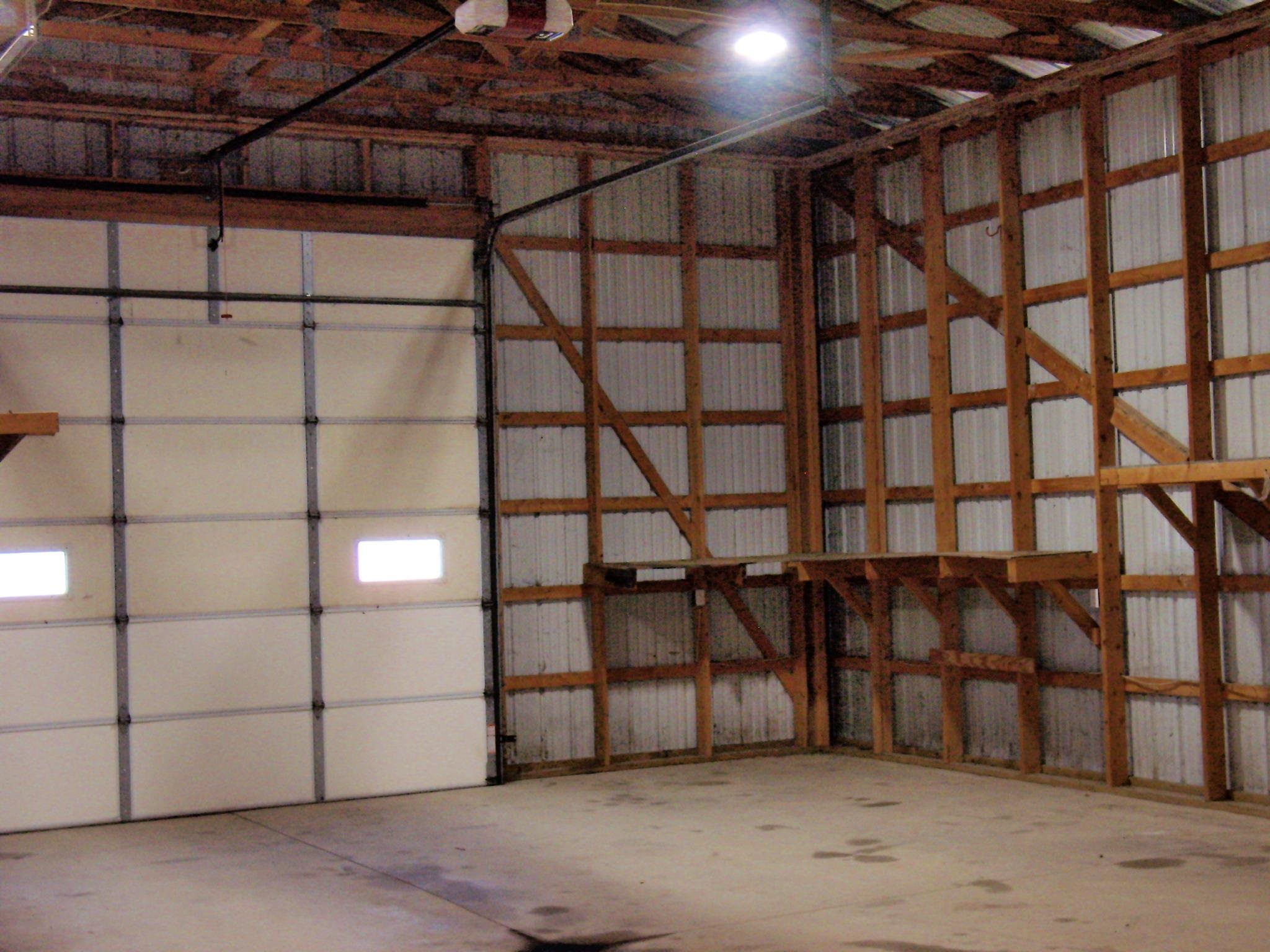 Interior workshop space featuring a large roll-up door with translucent panels