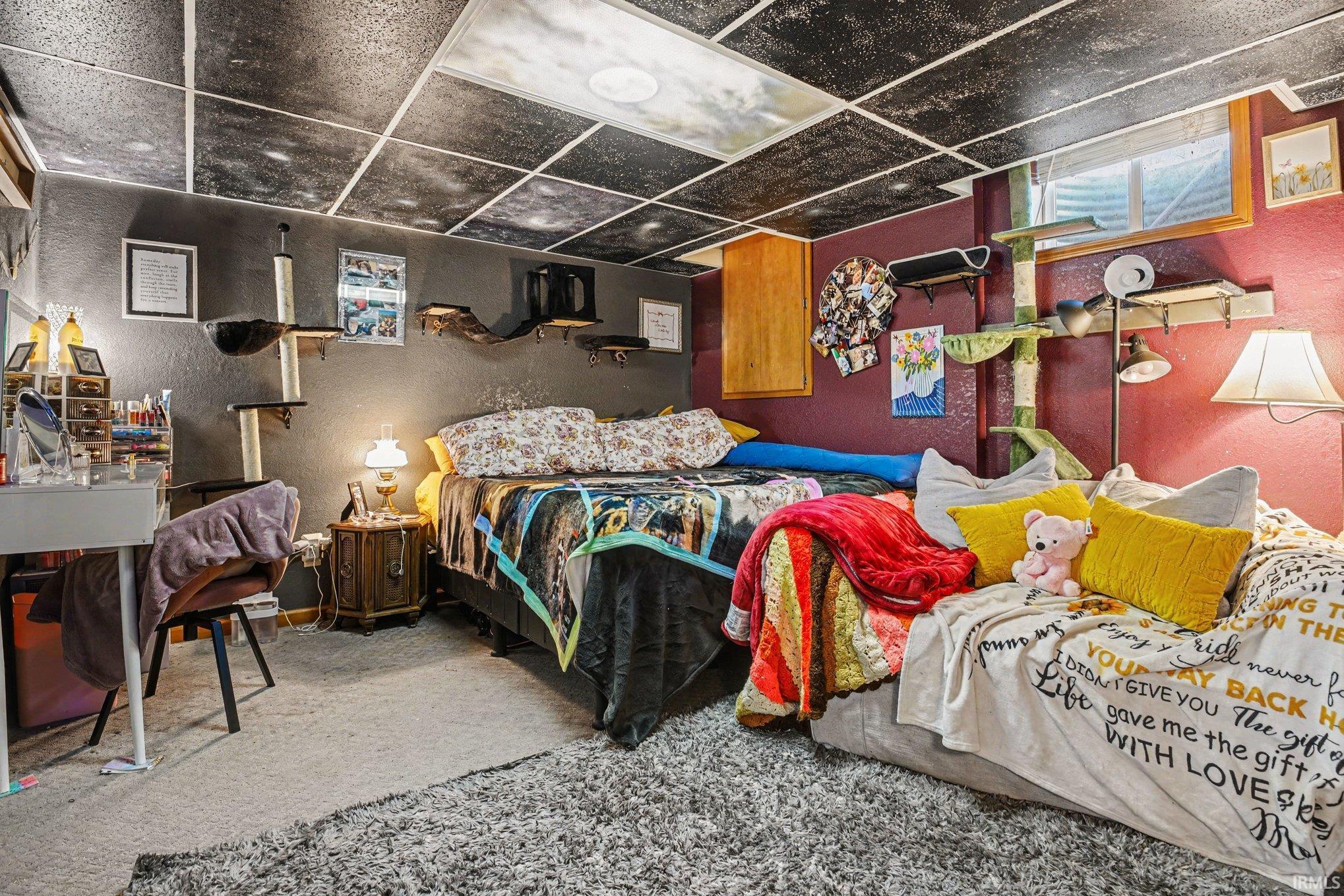 Carpeted interior space featuring a drop ceiling with recessed lighting