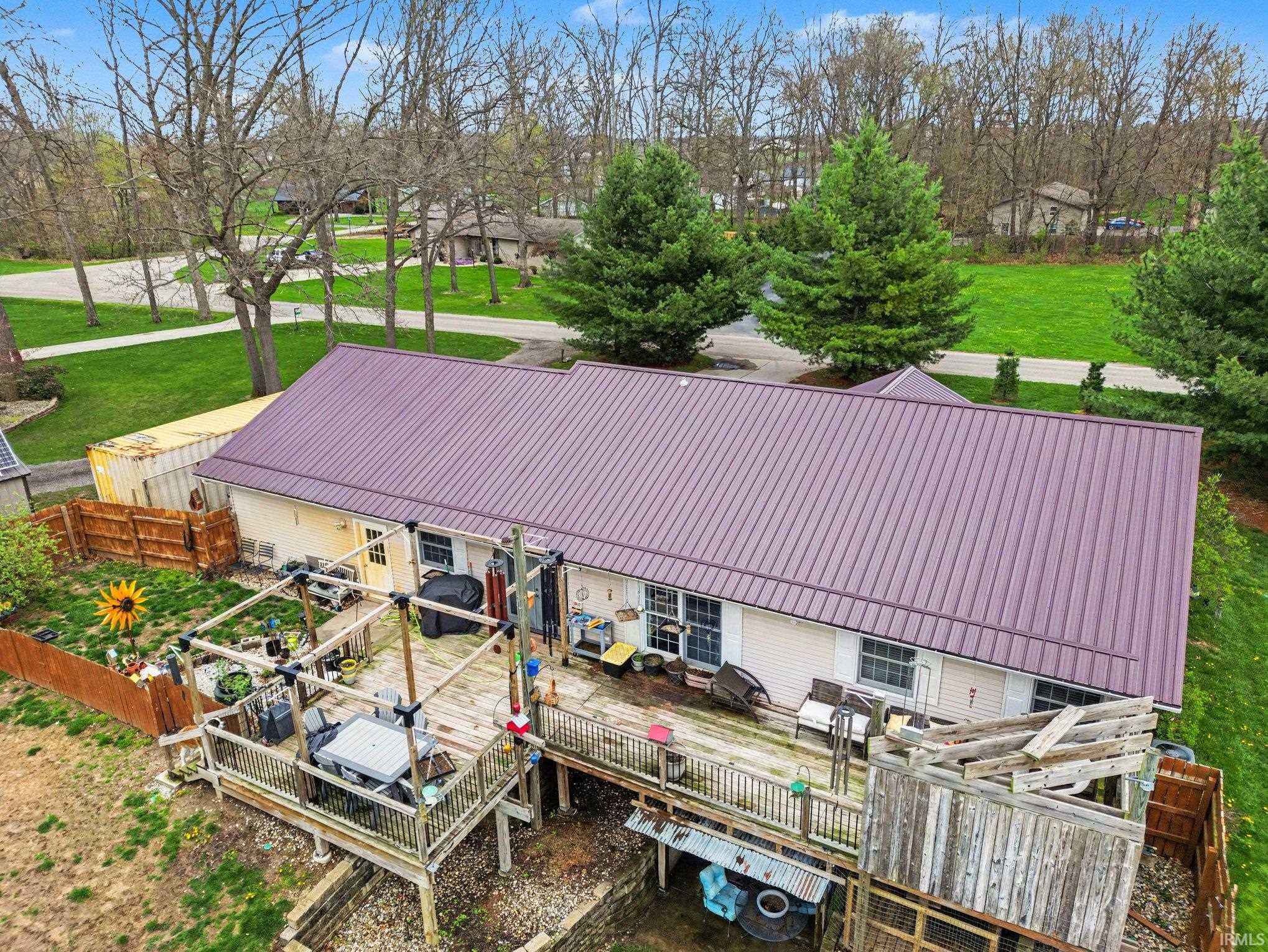 Rear exterior featuring a multi-level wooden deck with a pergola structure