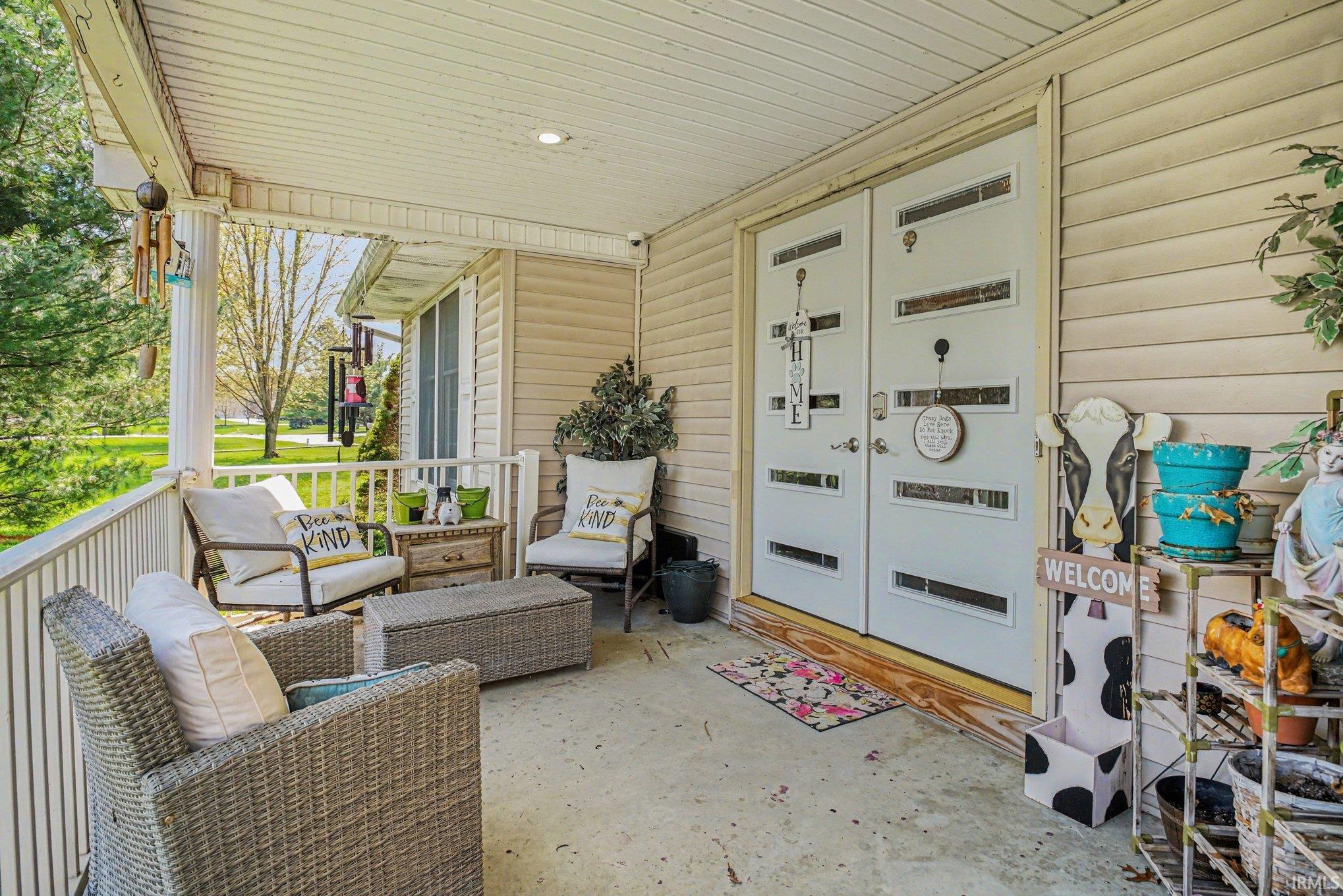 Inviting front porch featuring a covered ceiling and recessed lighting