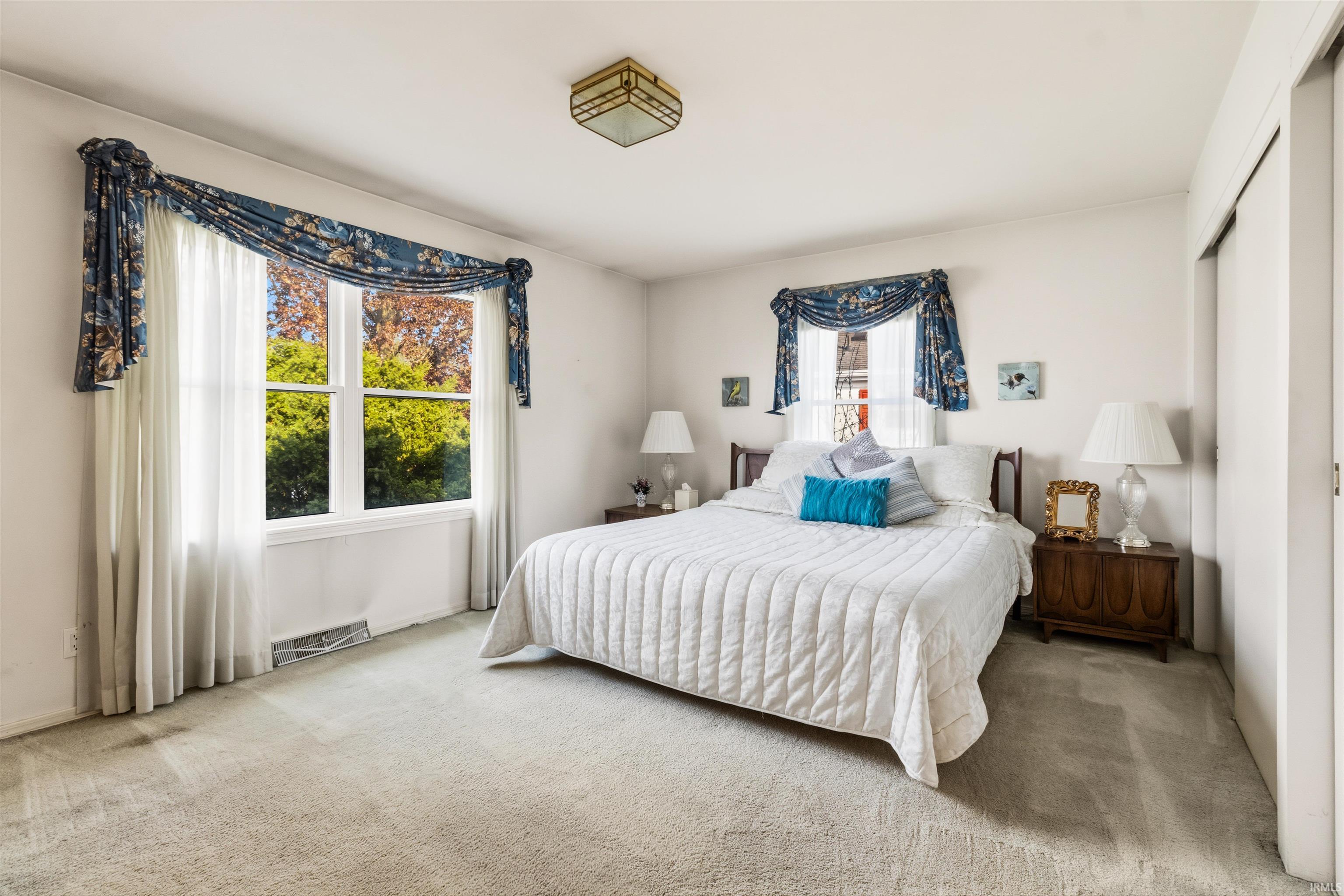 Light-filled room featuring a large double window and neutral wall color