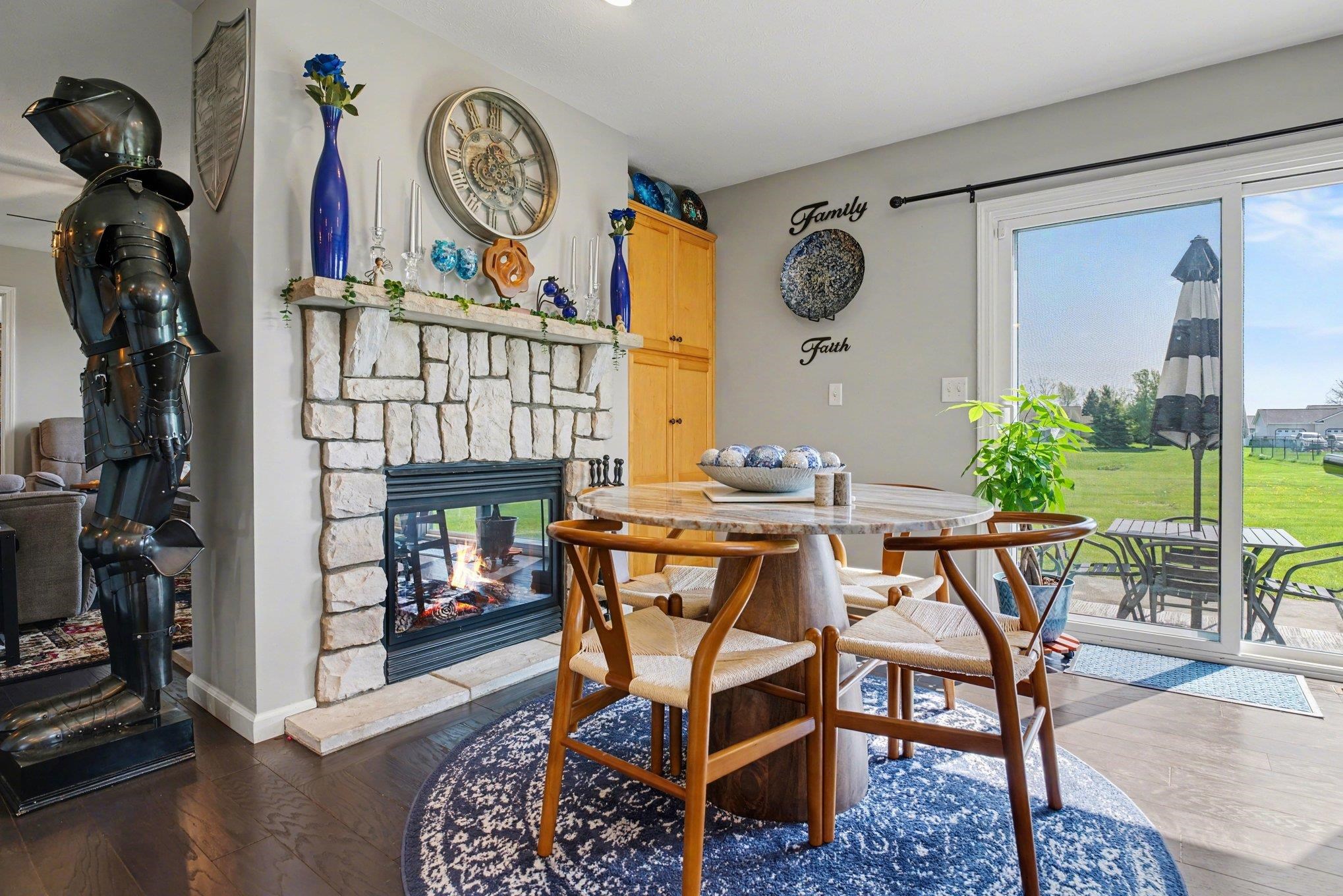 Stone-clad fireplace featuring a glass-front insert