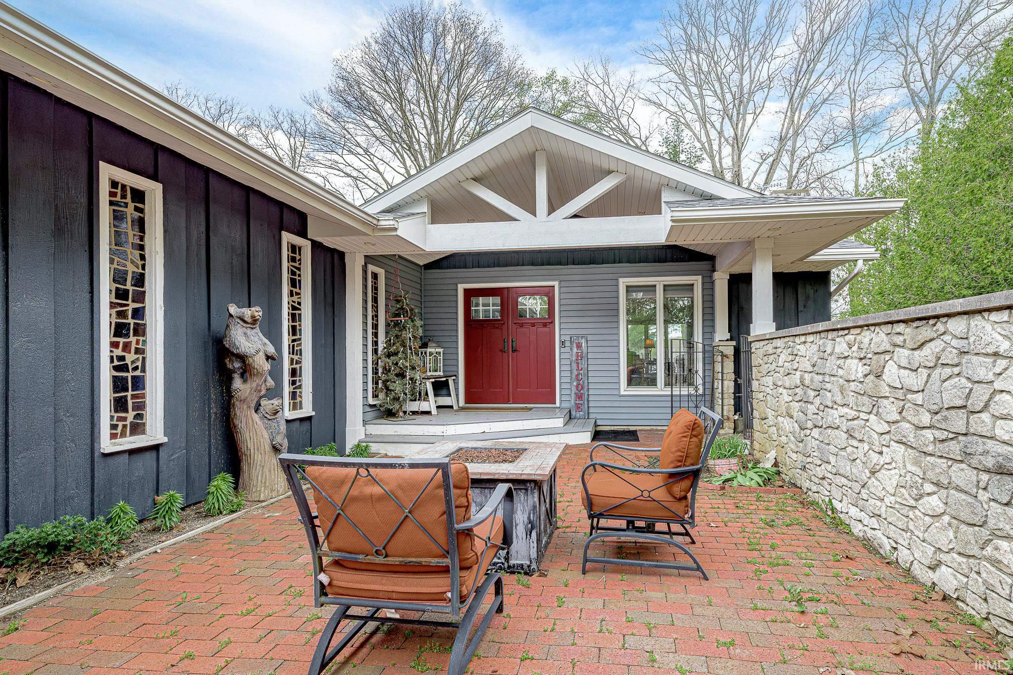 Brick paver patio featuring a stone privacy wall