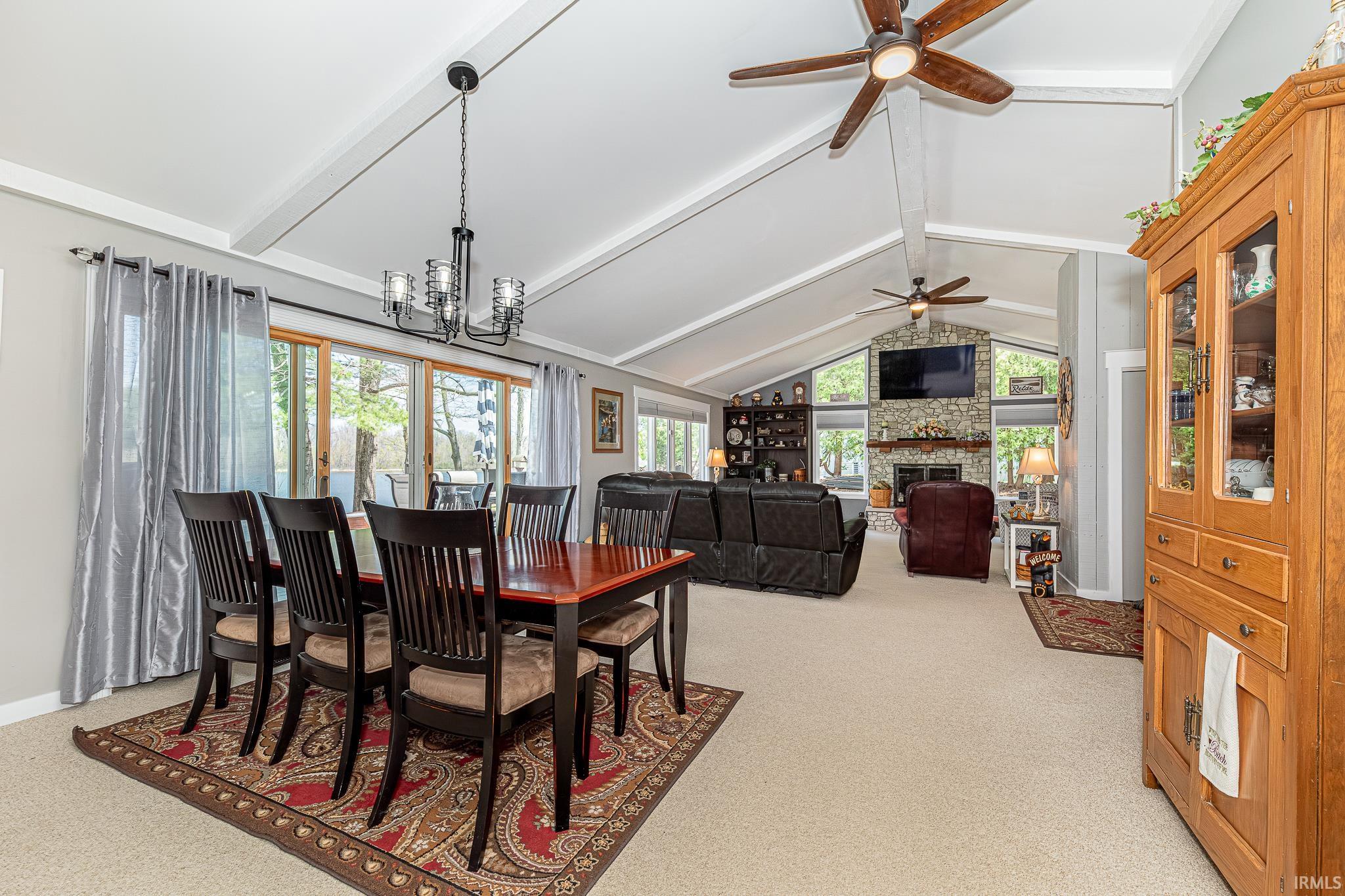 Vaulted ceilings with exposed beams and multiple ceiling fans