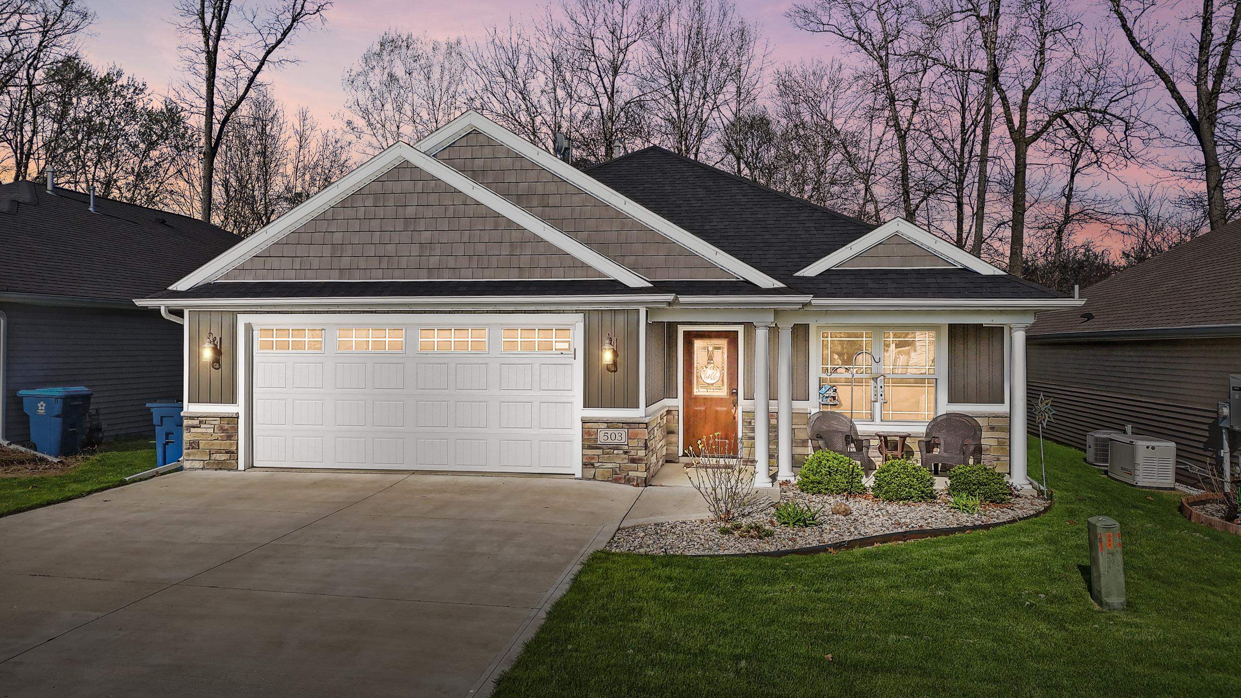 Ranch-style residence featuring a combination of horizontal siding, shake siding, and stone accents