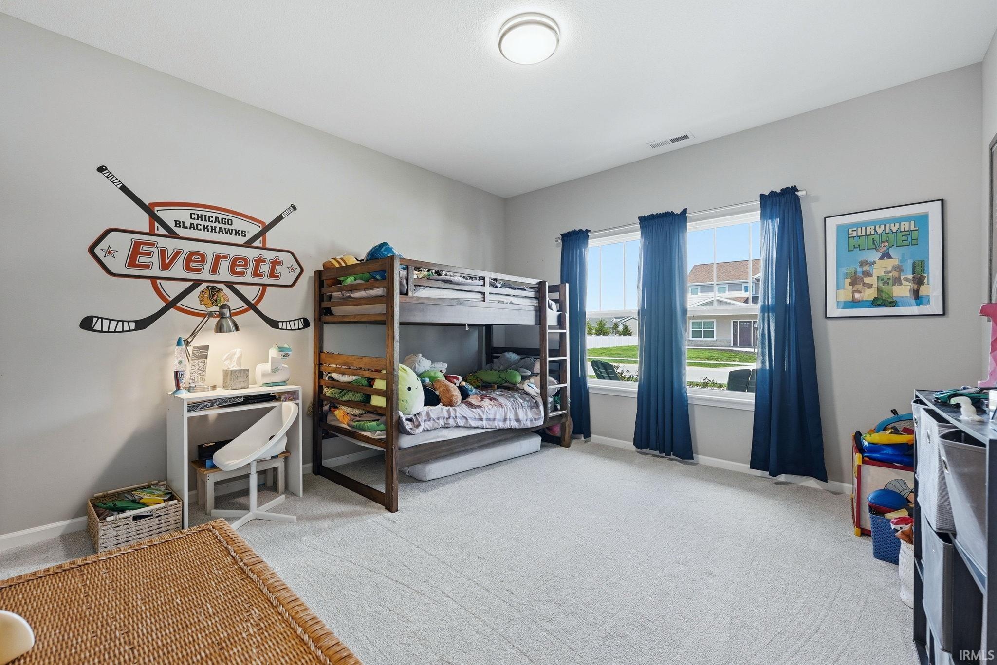 Bright room with light gray walls and plush gray carpeting