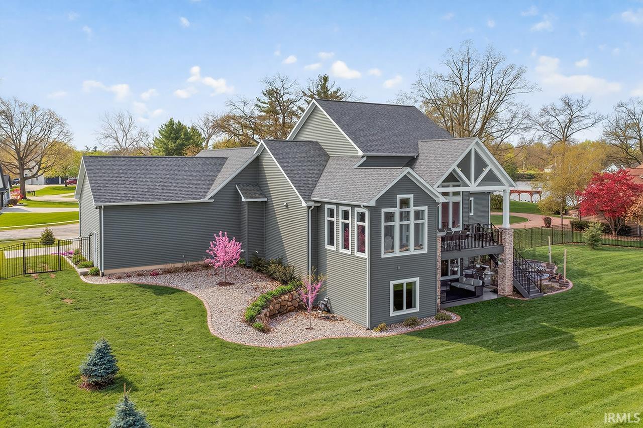 Contemporary multi-level exterior with dark gray siding and white trim