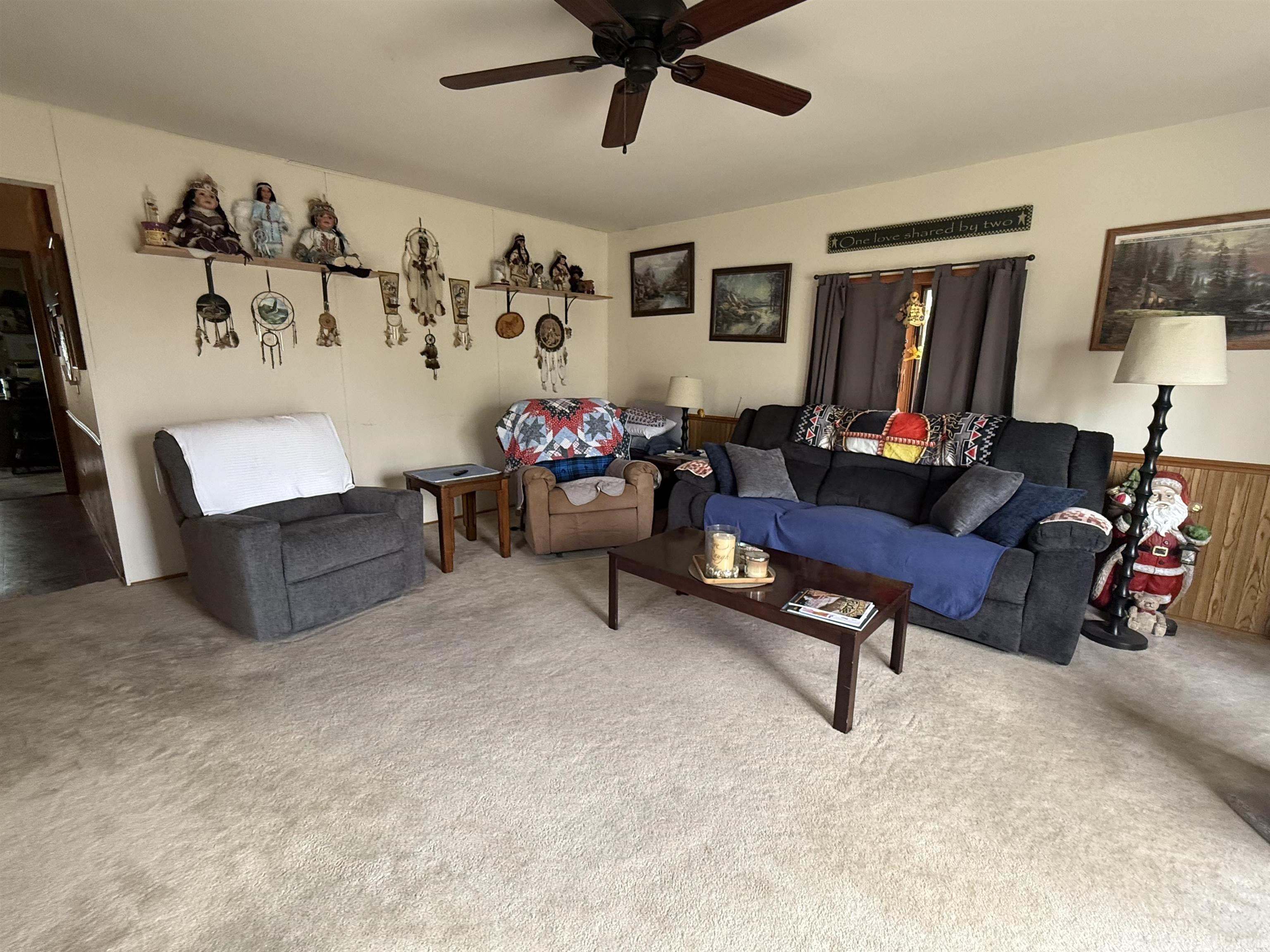 Spacious room featuring light-toned carpeting and light-colored walls