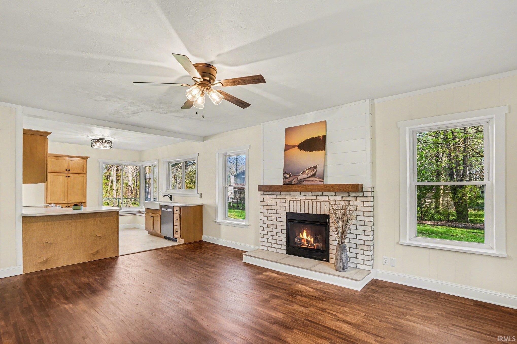 Living area with wood-finish flooring and a ceiling fan