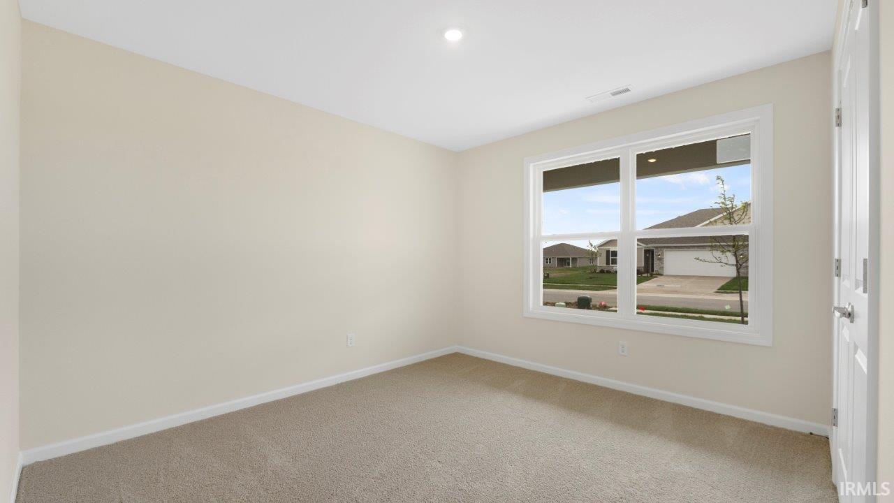 Light beige wall paint, neutral carpet flooring, and white trim