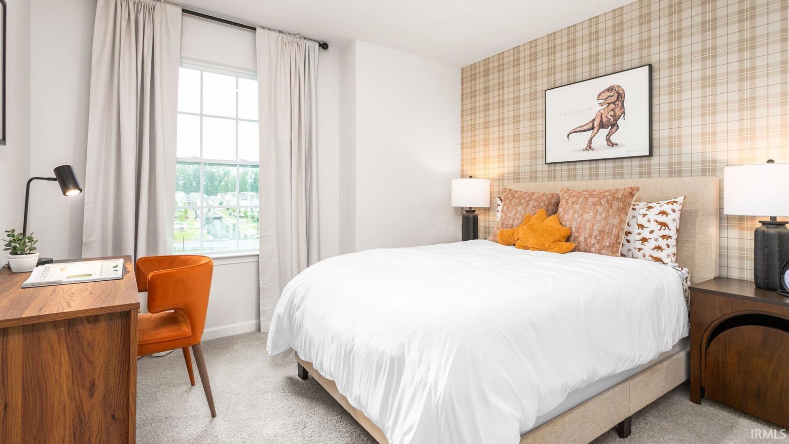 Bedroom featuring a large window, light gray carpet, and an accent wall with plaid wallpaper